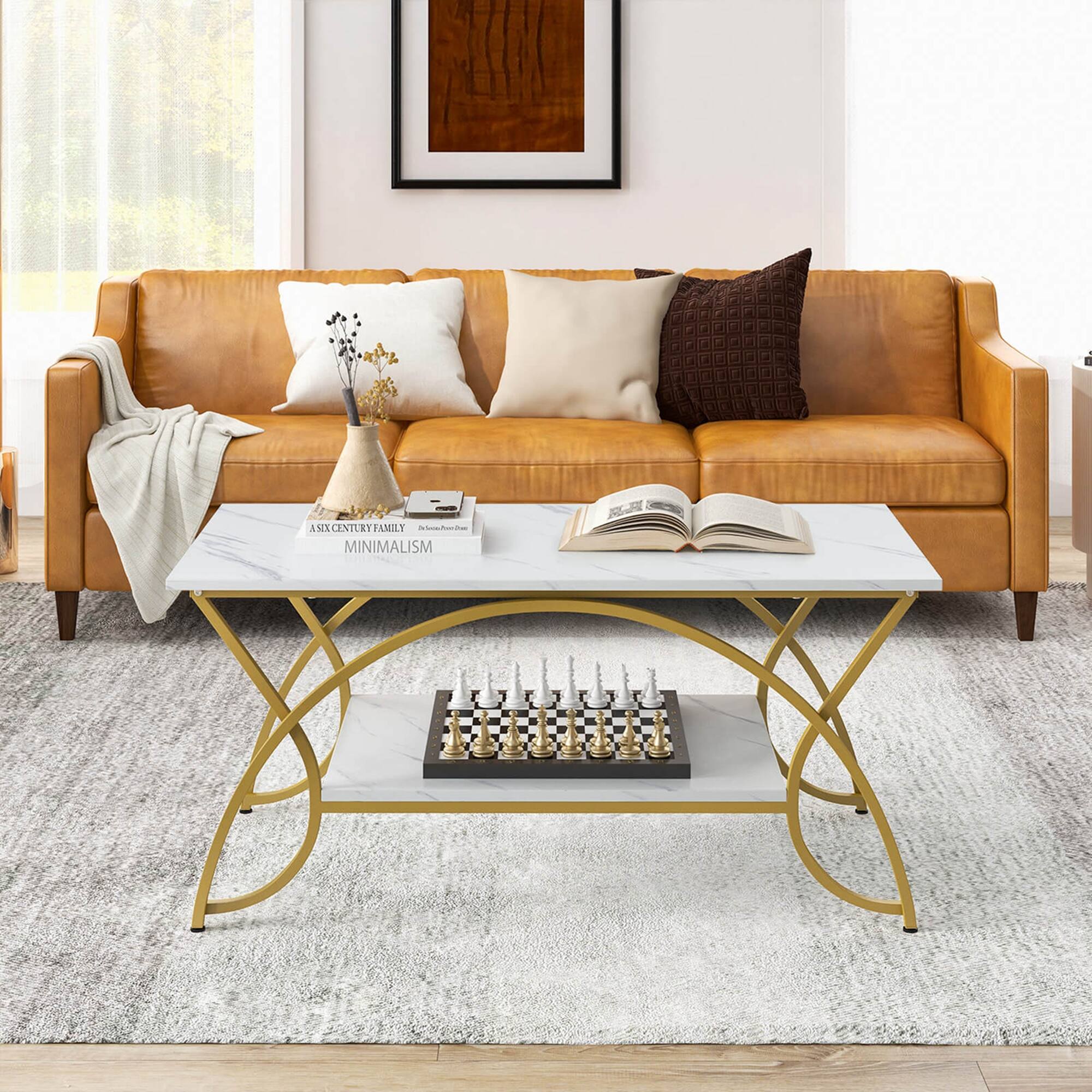 The image shows a living room with a couch, a coffee table, and a chess board. The couch is positioned against the wall, and there are several pillows on it. The coffee table is placed in front of the couch, and it has a chess board on top of it. The living room appears to be well-organized and minimalistic.