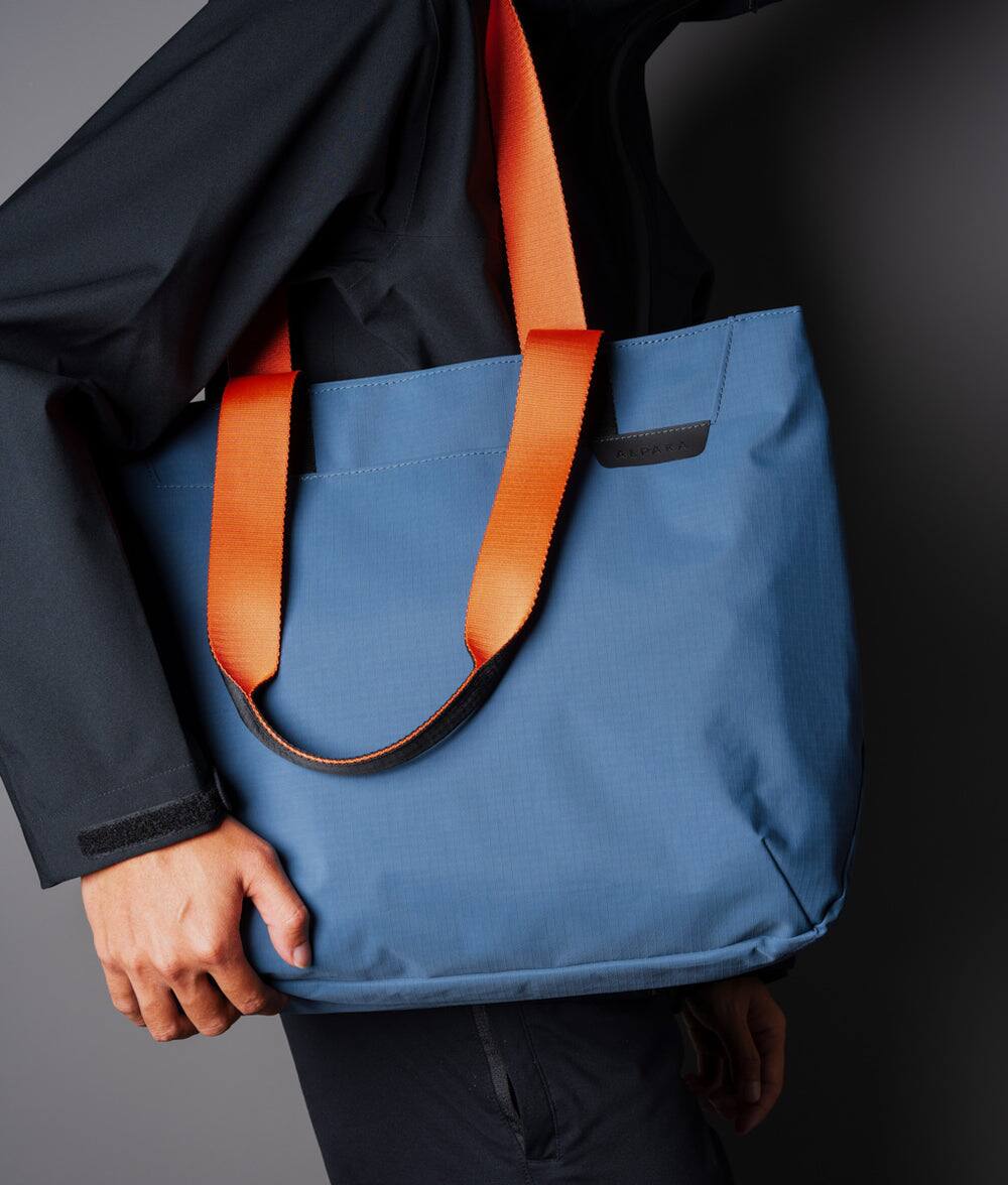 Left. ALPAKA - Elements Tote Bag 14.5L Weatherproof Foldable Travel Tote with Magnetic Closure - Blue Axoflux 210D.