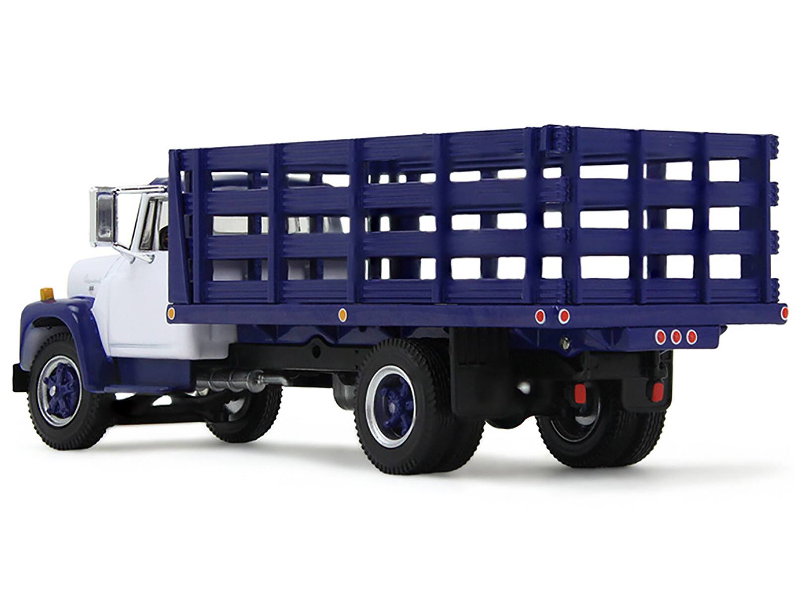 Left. First Gear - 1970s International Loadstar Stake Truck White and Navy Blue 1/64 Diecast Model by DCP/First Gear - White and Navy Blue.