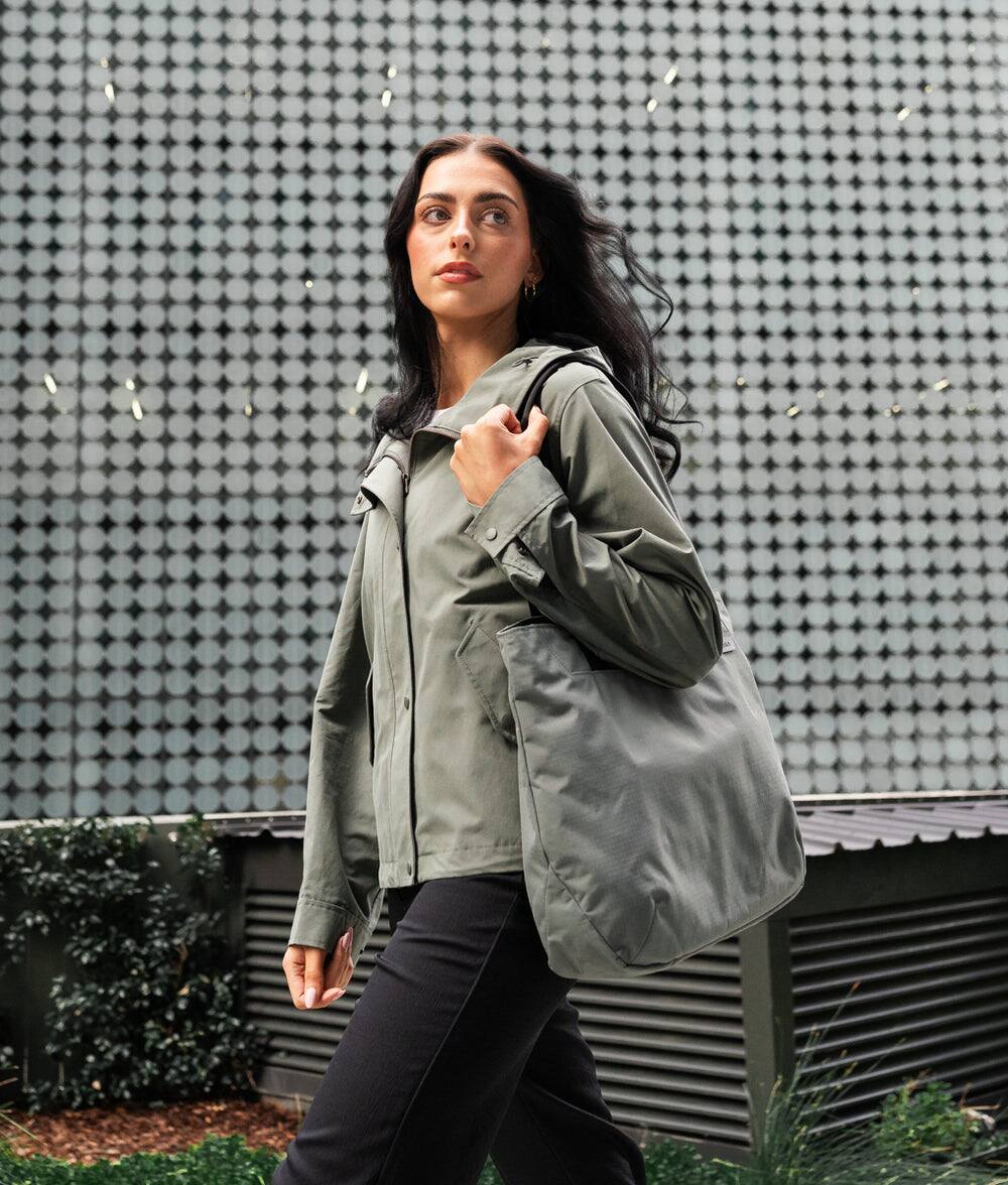 Angle. ALPAKA - Tote Bag Minimalist EDC Travel Tote,14.5L , 2 Bottle Sleeves, Front/Back Slip Pockets, Magnetic Open-Top (No Zipper) - Grey/G Axoflux 210D.