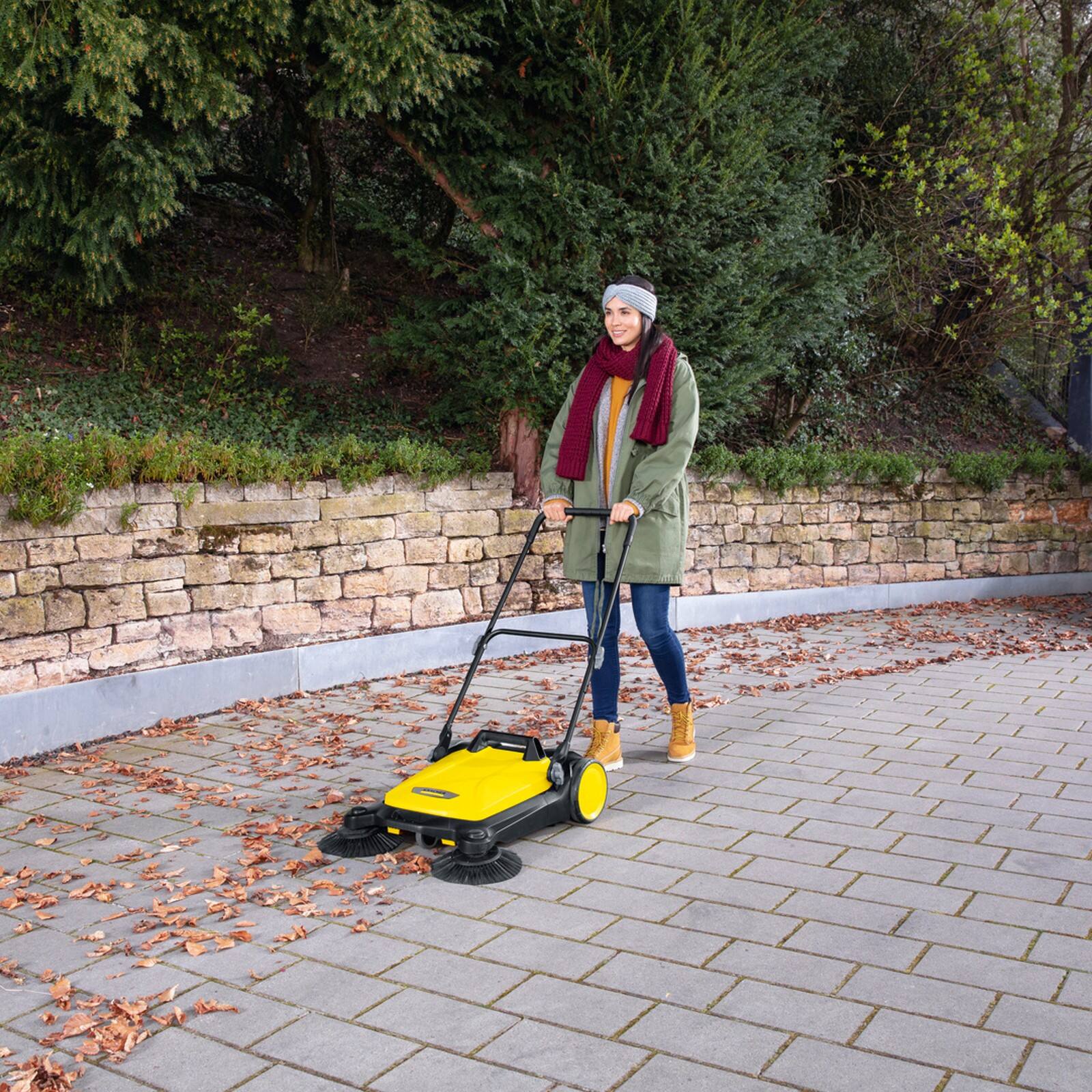 Left. Karcher - S 4 Twin Outdoor Push Sweeper, 5.25 Gallon, Walk-Behind Street Sweeper.