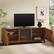 Alt View 3. Walker Edison - Reema 70" Modern Reeded TV Stand with Freestanding Electric Fireplace - English Oak.