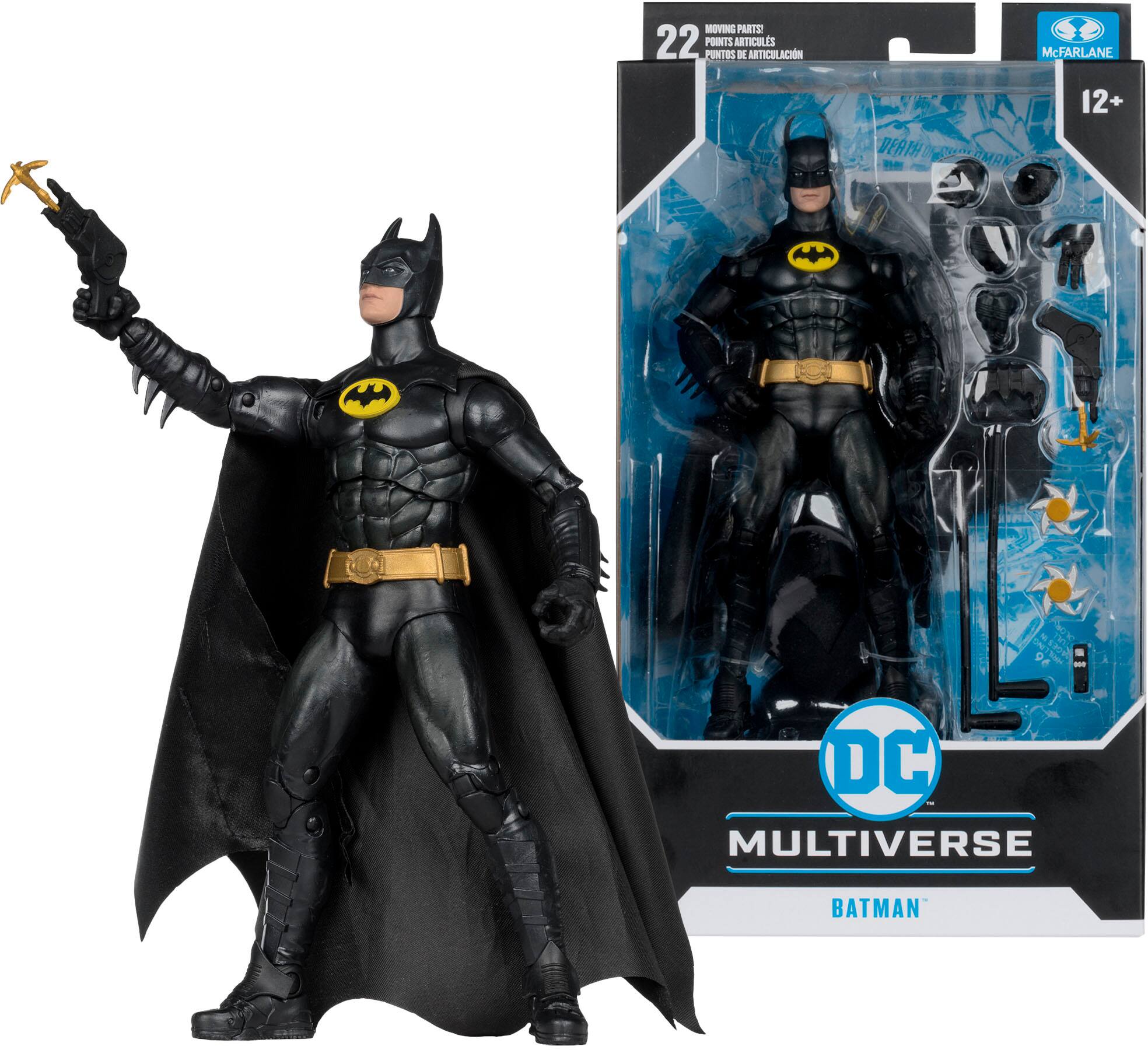 The image features a Batman action figure from the DC Multiverse line, standing next to its packaging. The figure is wearing a black and yellow suit and is holding a gun. The packaging is blue and white, and the figure is positioned in a dynamic pose, ready for action.
