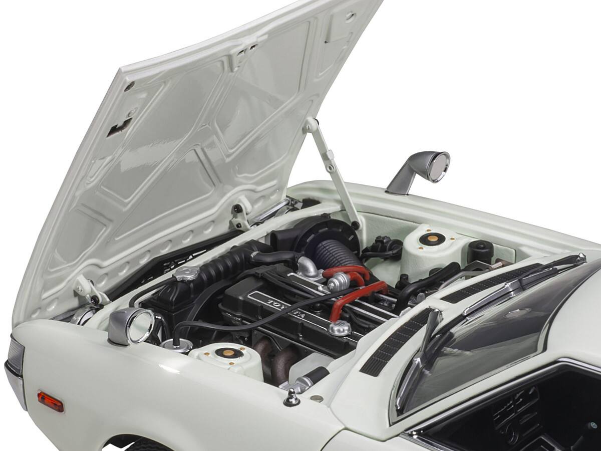 Angle. Autoart - 1973 Toyota Celica Liftback 2000GT (RA25) RHD (Right Hand Drive) White with Red and Black Stripes 1/18 - White With Red And Black.