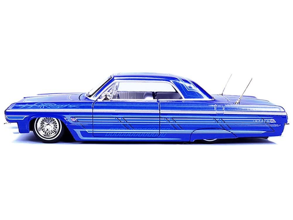 Left. Maisto - 1964 Chevrolet Impala SS Lowrider Candy Blue with Graphics and White Interior "Lowriders" "Maisto Design" Series 1/26 - Candy Blue and White.