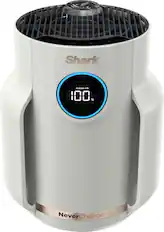 The image features a white Shark air purifier that is designed to clean the air and remove dust and pollutants. The air purifier is equipped with filters that can remove up to 99.97% of PM1.0, PM2.5, and PM10 particles, ensuring that the air in the room remains clean and healthy. The NeverChange feature of the air purifier ensures that it remains effective and efficient in maintaining the air quality without the need for frequent filter replacements.