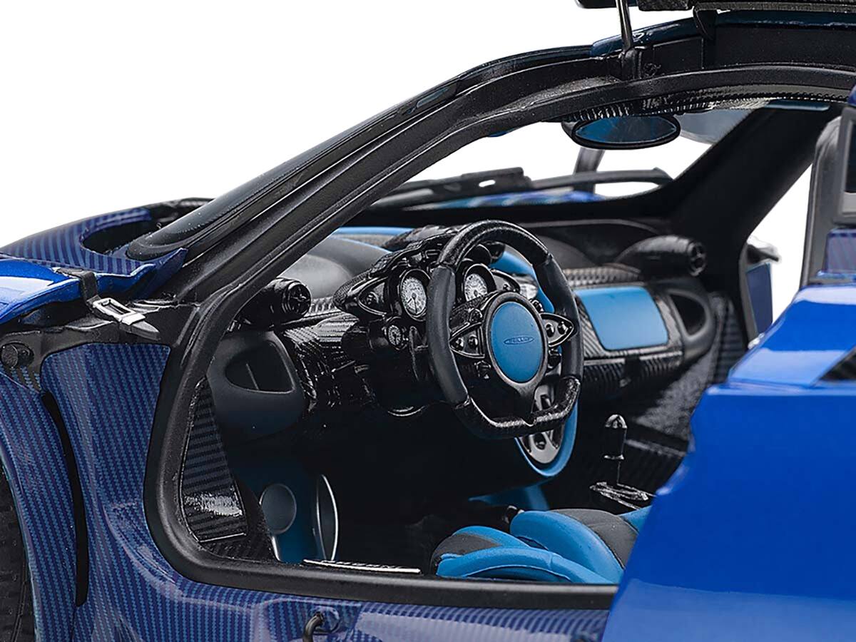 Left. Autoart - Pagani Huayra BC Blu Francia / Candy Blue Metallic with Carbon Accents 1/18 Model Car by Autoart - Blue Metallic With Carbon.