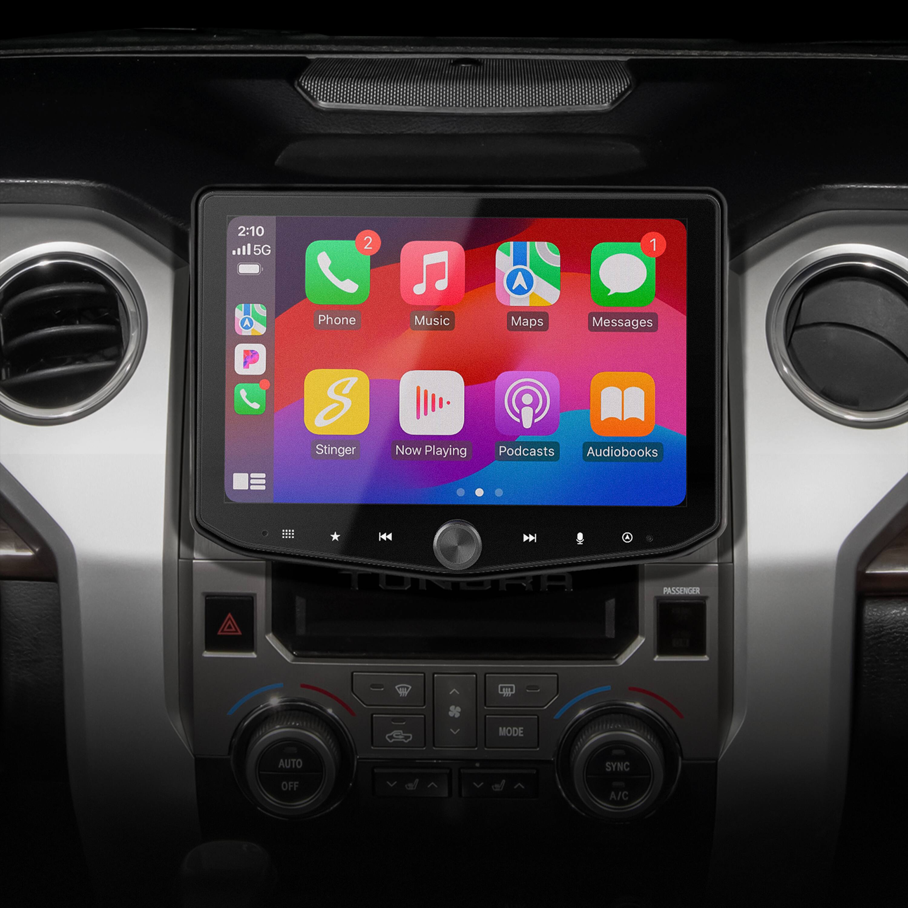 The text on the image reads:

2:10 5G 2  Phone  Music  Maps  Messages  S Stinger  Now Playing  Podcasts  Audiobooks .111 ... H44  TURGRA PASSENER uL MODE AUTO SYNC OFF A/C

The text has been grouped and corrected as follows:

2:10 5G 2 Phone Music Maps Messages S Stinger Now Playing Podcasts Audiobooks .111 ... H44 TURGRA PASSENER uL MODE AUTO SYNC OFF A/C