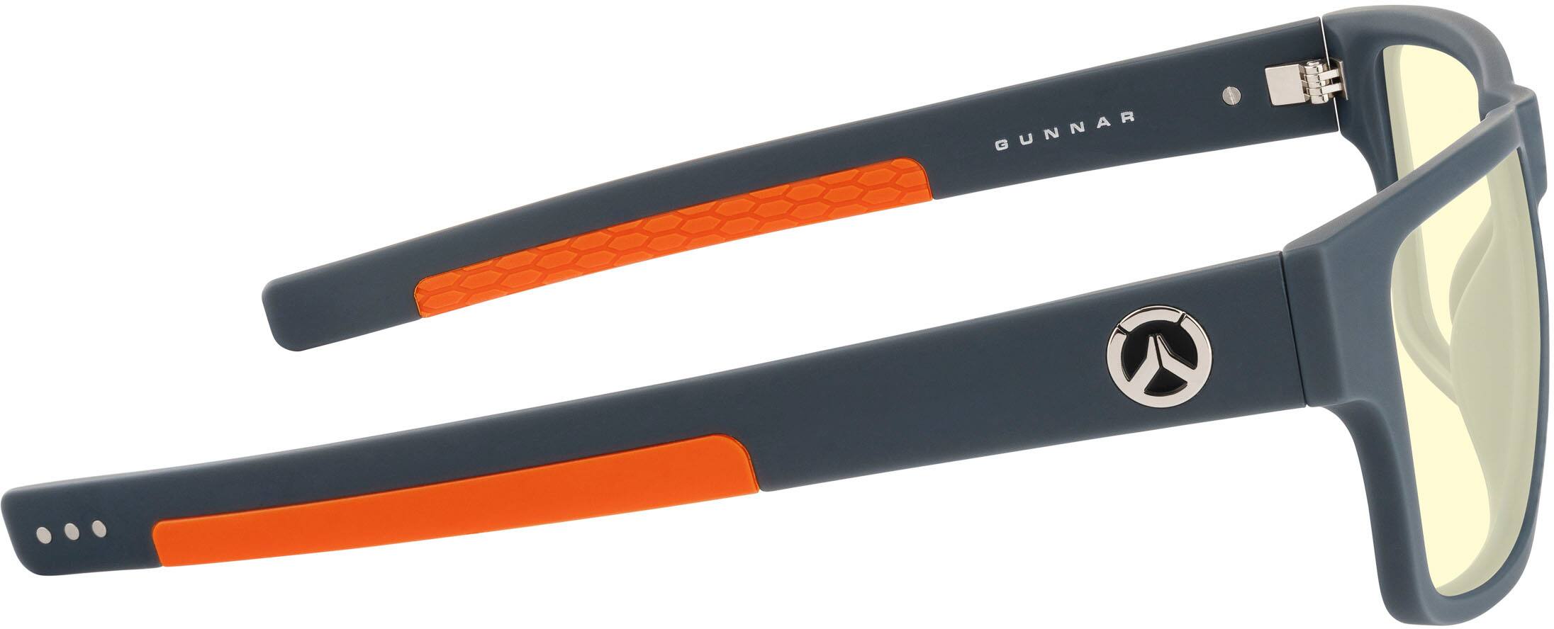 GUNNAR is a brand of sunglasses known for their high-quality lenses and ergonomic design. The sunglasses in the image feature a sleek black frame with orange accents, and they are designed to provide comfort and protection for the wearer. The lenses of these sunglasses are made of high-quality materials, ensuring clear vision and protection from harmful UV rays. The sunglasses are also equipped with a clip for attaching them to clothing or other objects, making them a convenient and practical accessory for outdoor activities or daily wear.