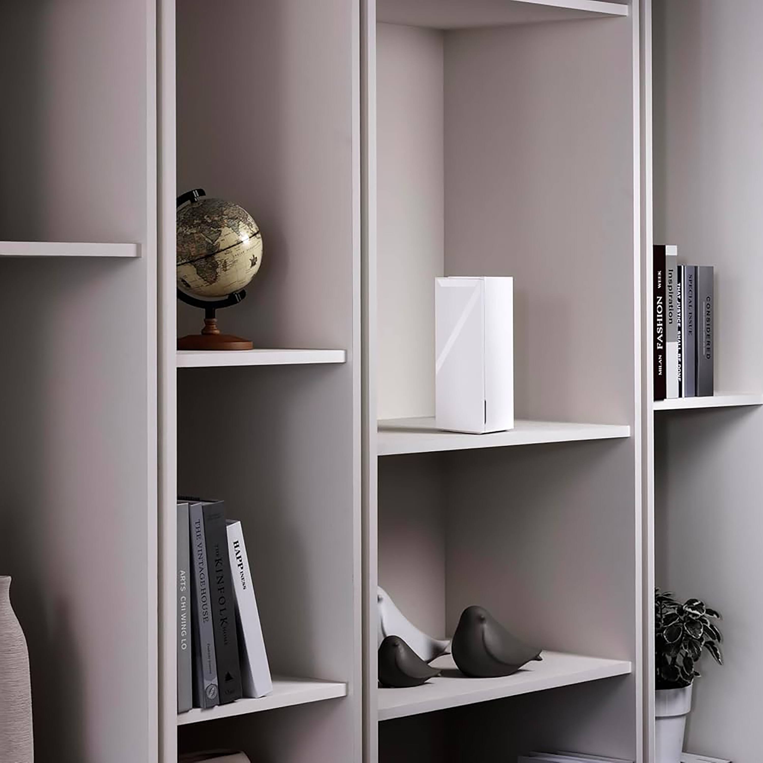 Fashion meets art in the vintage house. Considered one of the most inspiring places to be, the vintage house offers a unique blend of fashion and art, creating a harmonious and visually appealing environment. The shelves are filled with books, and a globe is displayed on one of the shelves, adding to the overall aesthetic of the space.