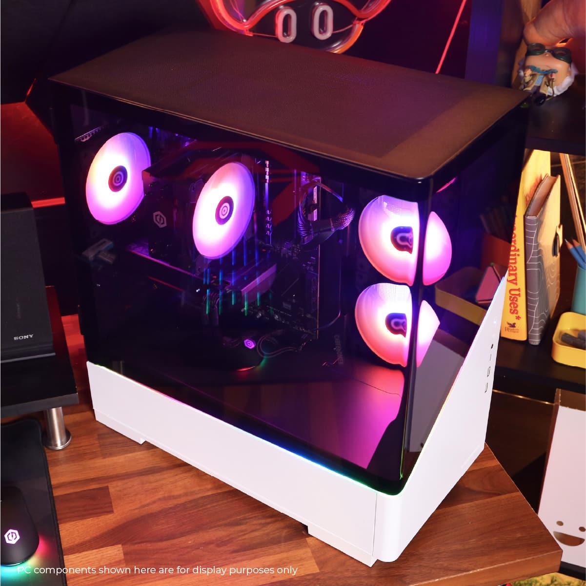 The image displays a computer case with a purple light on it. The case is open, revealing the components inside. The case is placed on a wooden table.