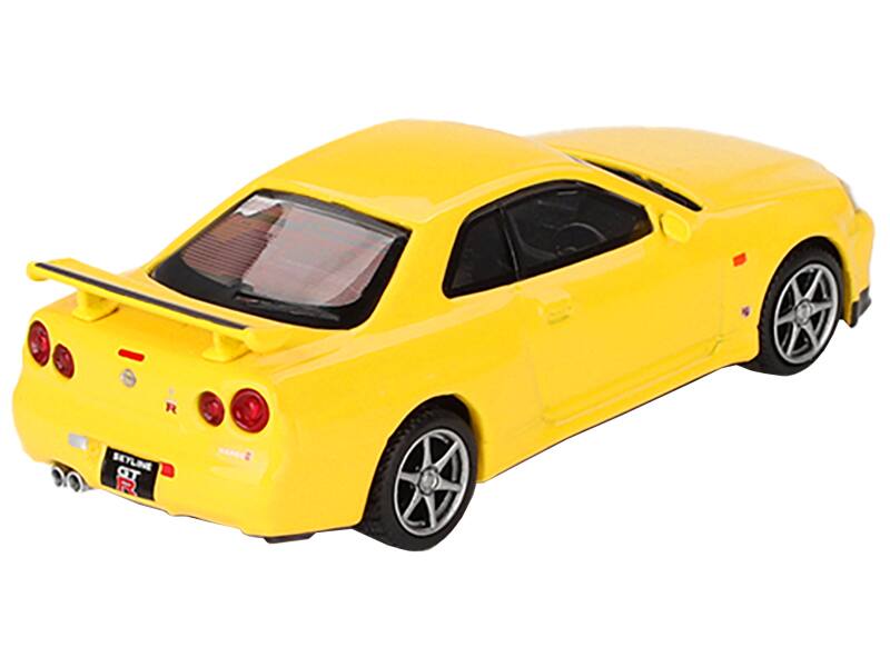 Left. Mini GT - Nissan Skyline GT-R (R34) V-Spec RHD (Right Hand Drive) Lightning Yellow Limited Edition to 7920 pieces Worldwide 1/64 - Yellow.