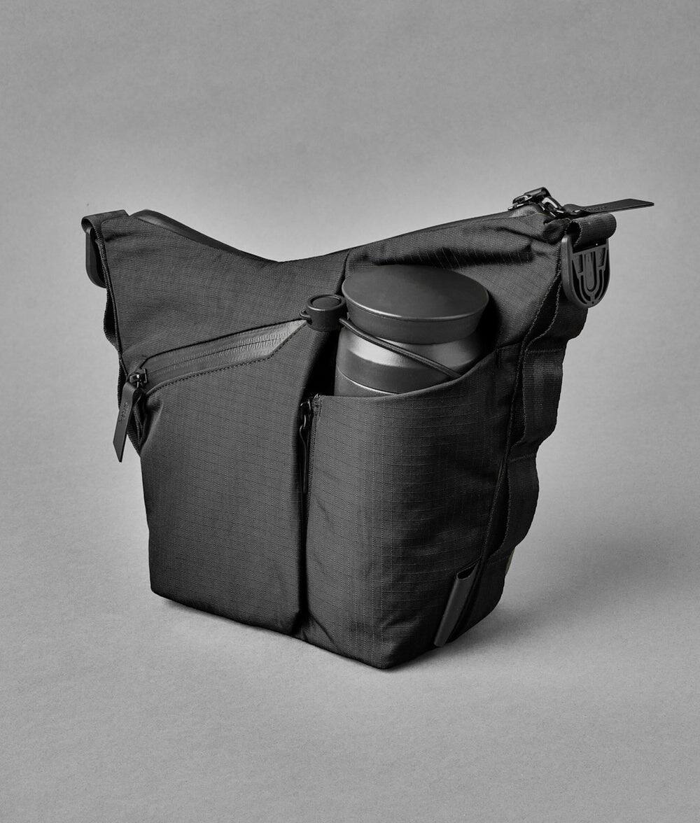 Alt View 1. ALPAKA - Flow Satchel Mini 2L Crossbody Bag, Water Resistant Shoulder Bag, Expandable Bottle Pocket, YKK Zippers - Black Axoflux 210D.