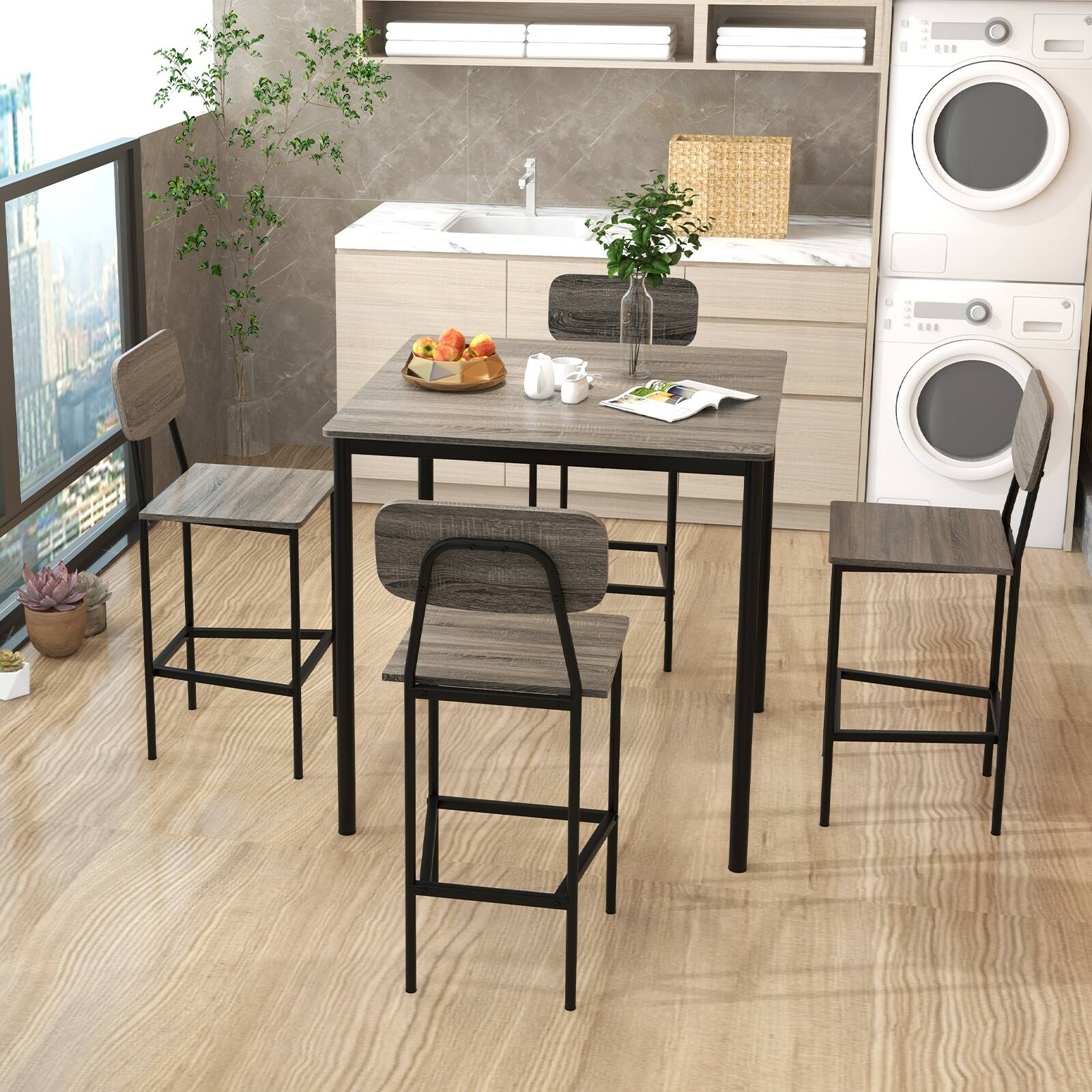 The image does not contain any text. It shows a modern kitchen and laundry area with a dining table, chairs, a sink, a washing machine, and some decorative items.