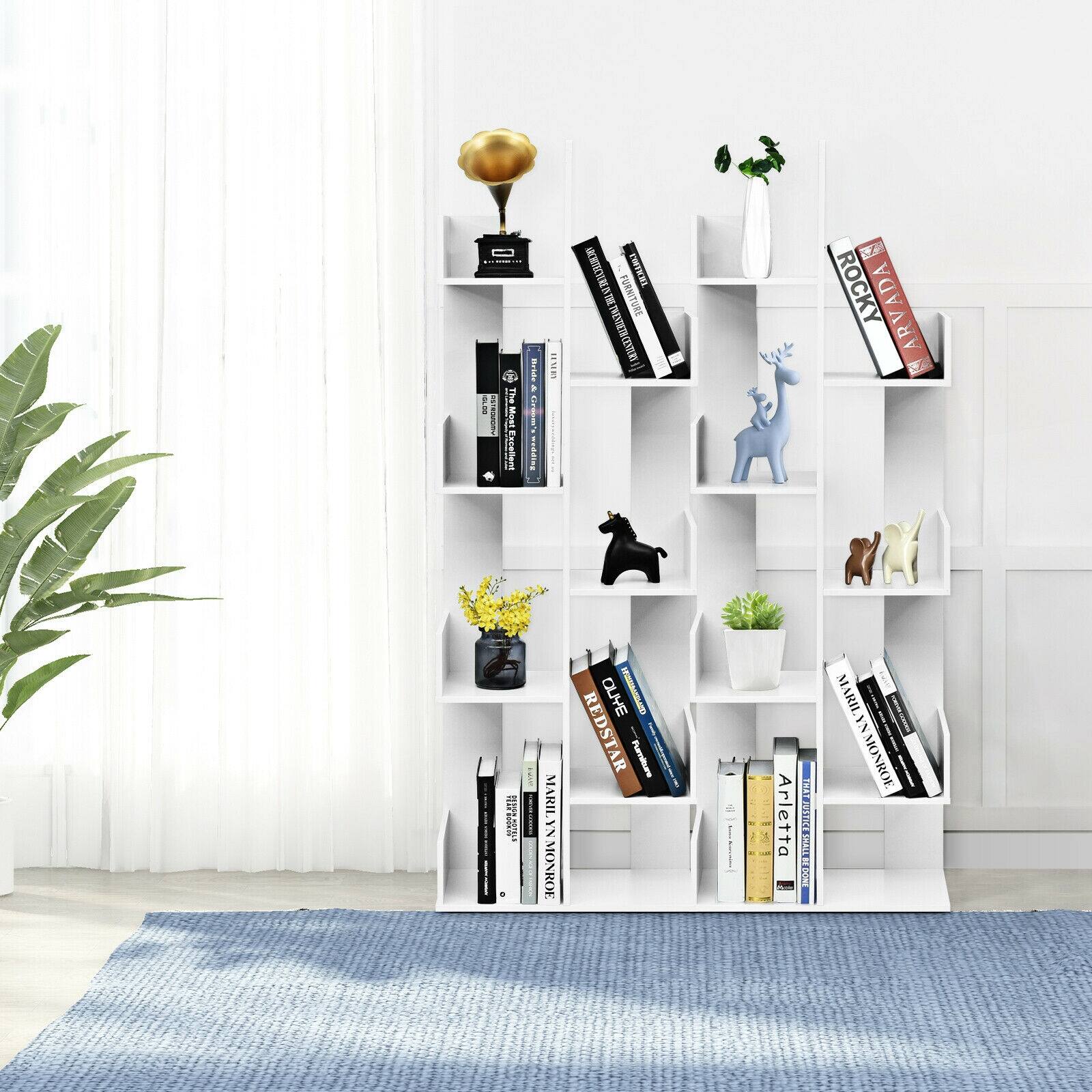 The Moet Escellen I furniture is displayed on a bookshelf. The bookshelf is filled with books and has a vase on top. The books are arranged in a way that makes the bookshelf look organized and visually appealing.