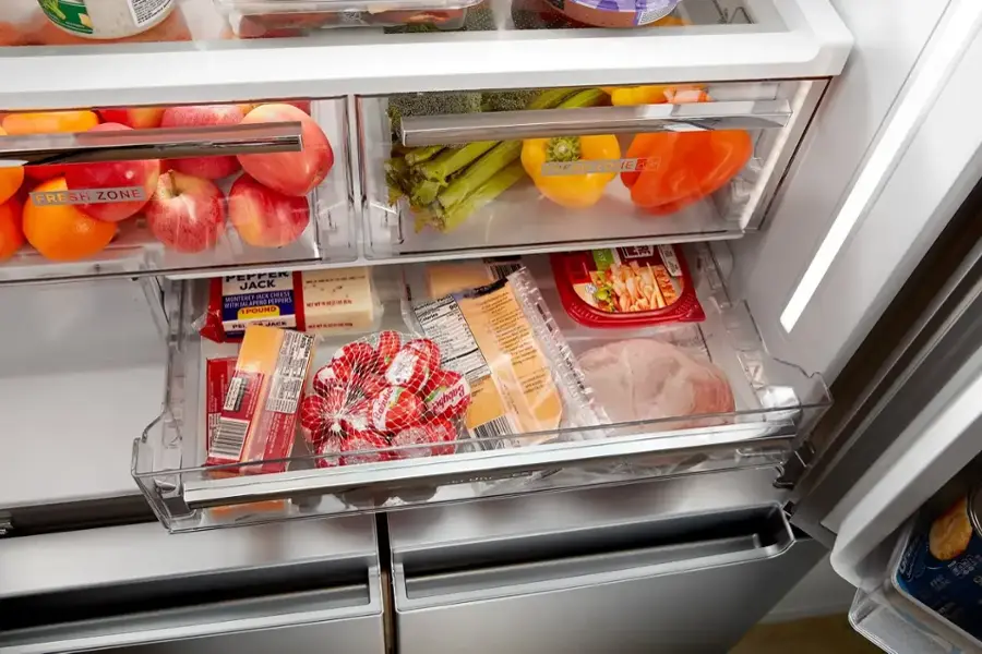 Fresh Zone:

* Pepper Jack Cheese
* Peppers
* Babybel Cheese
* Balpeno

The image shows the interior of a refrigerator with various food items stored in it. The refrigerator is filled with a variety of items, including a bowl of food, a tray of meat, and a tray of vegetables. The refrigerator is well-stocked, indicating that it is ready for use.