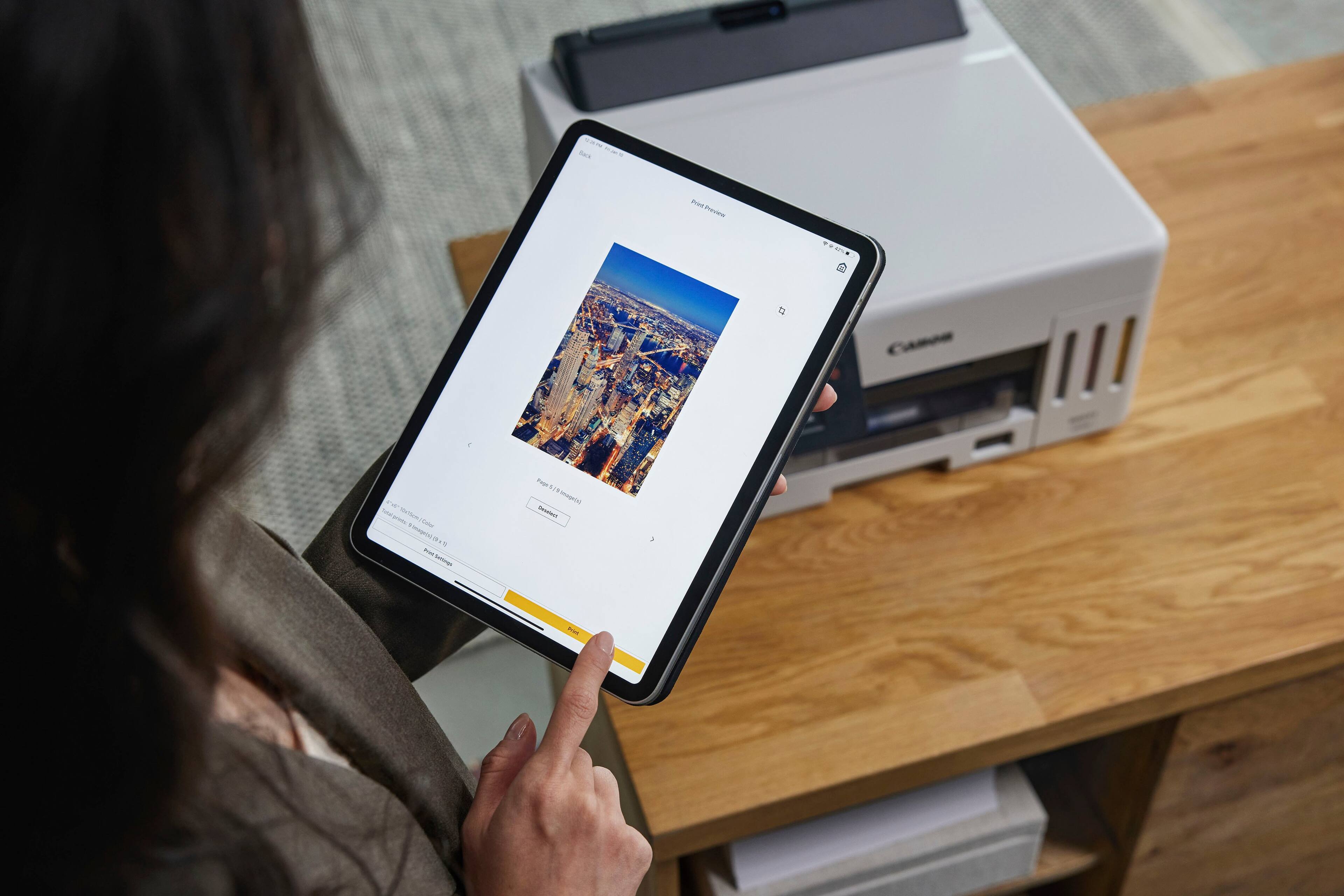 The text on the image reads: "T Base SAS nu nevew an 4 aar Na nT inmpi - . - Sumoogs T 1 . Himeortl nes os". This text is in a foreign language and does not appear to be related to the image of a person holding a tablet computer.