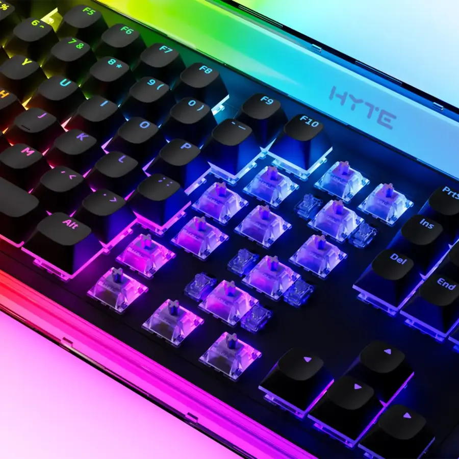 The image features a colorful keyboard with a rainbow theme, which is a product of the Hyte brand. The keyboard has a unique design, with each key featuring a different color. The keys are arranged in a way that makes them easily distinguishable and visually appealing. The keyboard is placed on a white background, which further highlights its vibrant colors.