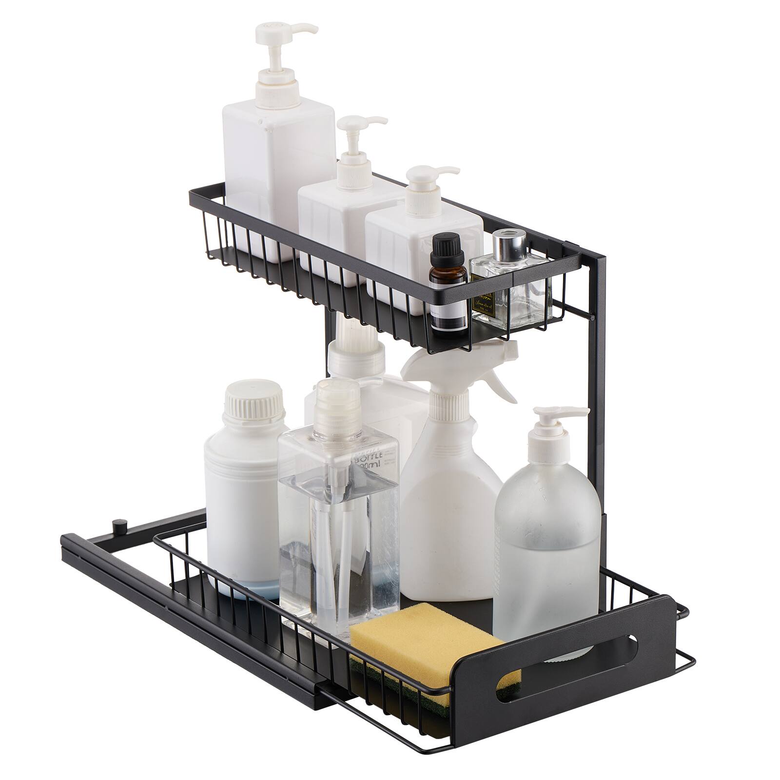 The image shows a black two-tiered metal rack holding various bottles and containers. On the top tier, there are three white pump bottles, likely for soap or lotion, and a small dark-colored bottle. The bottom tier has a larger white pump bottle, a clear glass bottle, and a smaller white bottle, along with a yellow sponge.