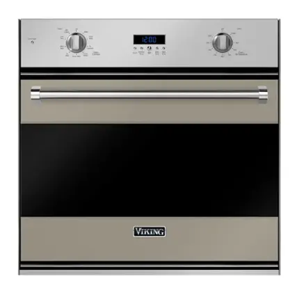 The image features a Viking oven with a digital clock displaying the time as 12:00. The oven is a stainless steel appliance, and the clock is located on the front of the oven. The oven is likely a part of a larger kitchen setup, providing a convenient way to keep track of time while cooking or baking.