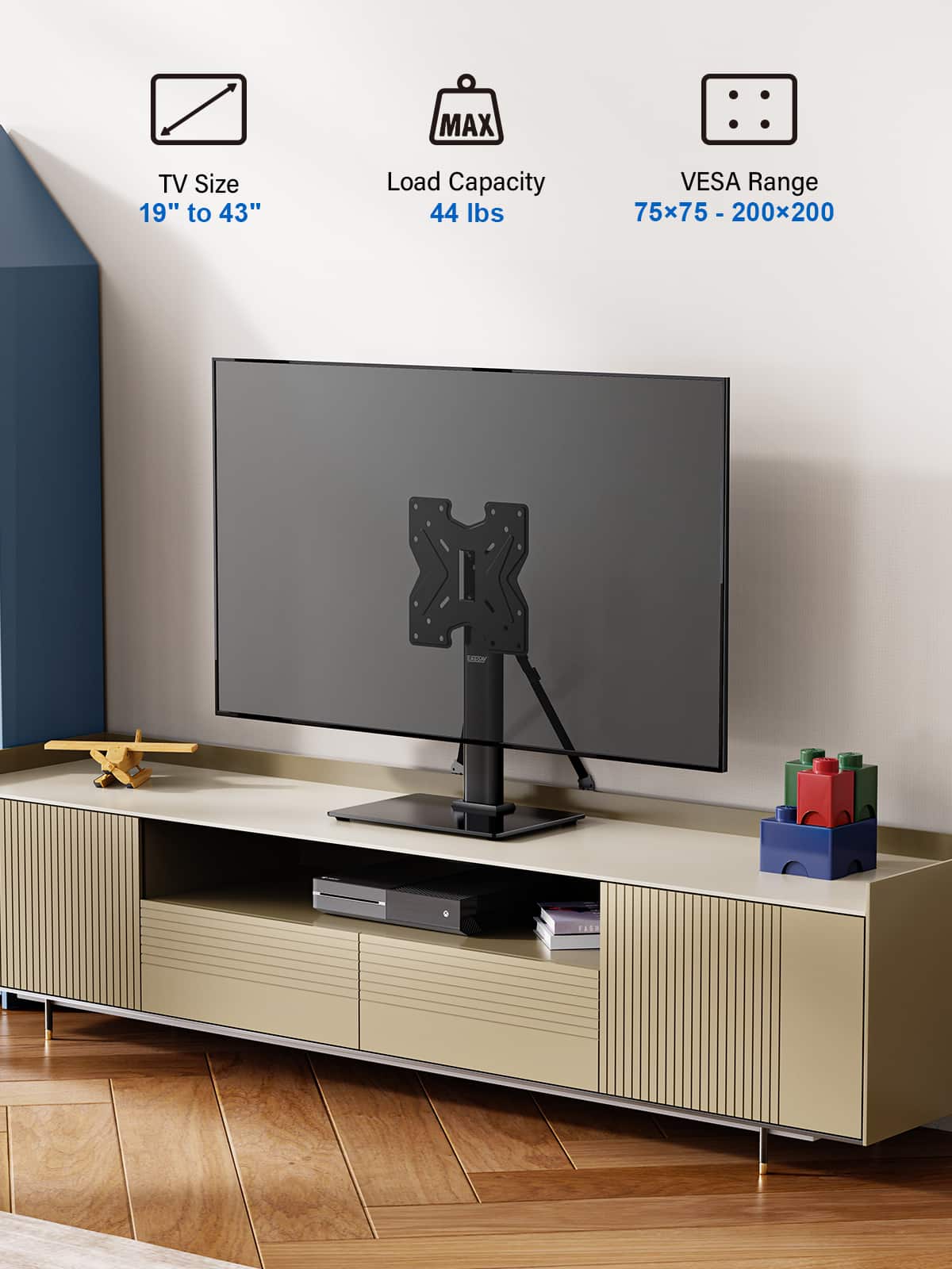 The image features a flat screen TV mounted on a wall, with a wooden stand underneath it. The TV is described as having a MAX TV Size of 19" to 43" and a Load Capacity of 44 lbs. The VESA Range is listed as 75x75 - 200x200 - x 200. The TV is placed on a wooden stand that has a shelf underneath it.