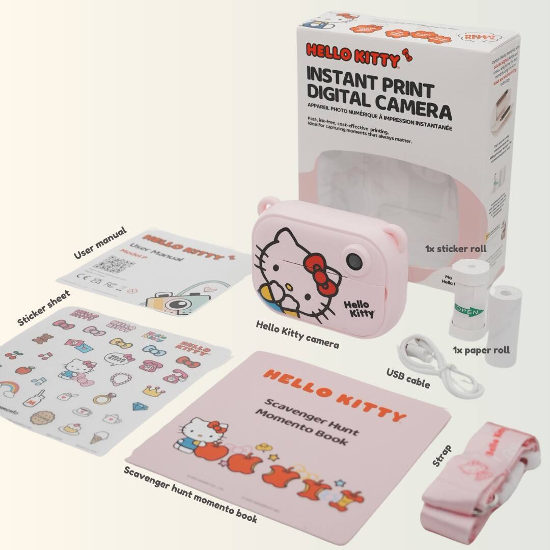 Hello Kitty Instant Print - Digital Camera: A cost-effective and efficient way to capture moments that matter. The camera comes with a manual and a sticker roll, as well as a Hello Kitty paper roll and a USB cable. The camera is pink and features a Hello Kitty design. The package also includes a scavenger hunt momento book.