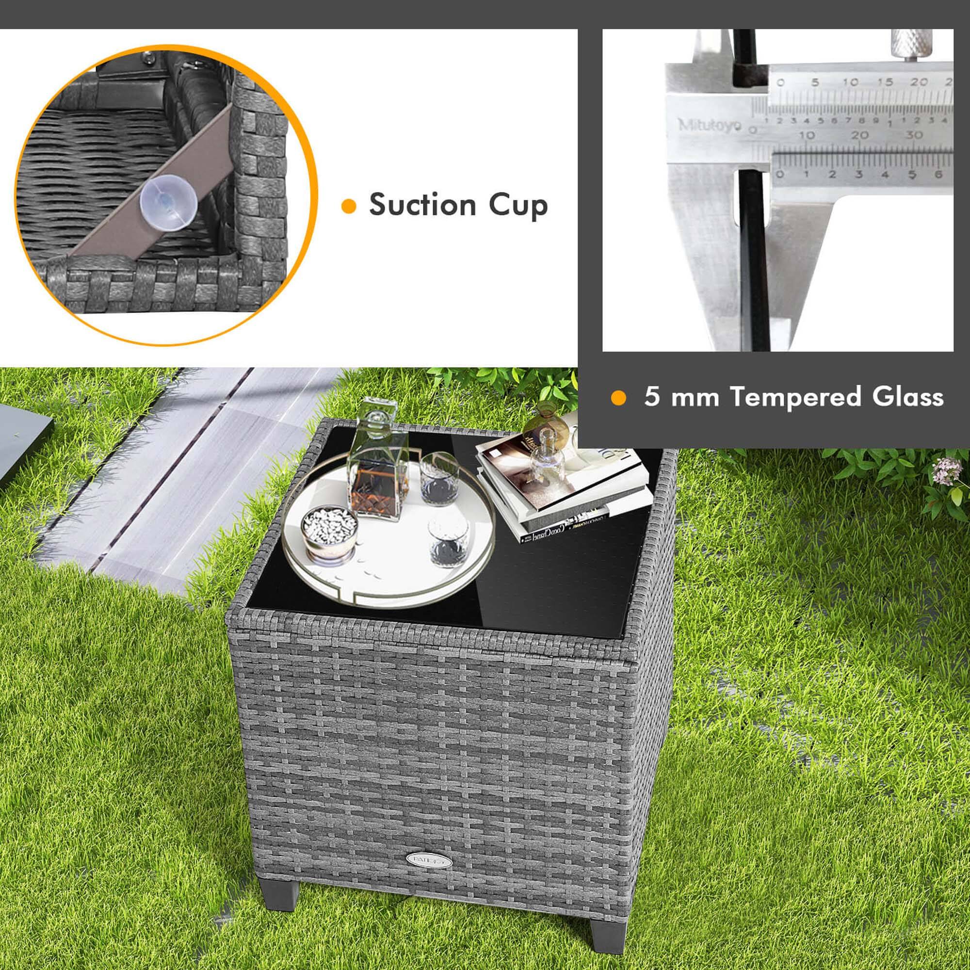 The image features a table with a measuring tape and a suction cup. The measuring tape is displayed in the top right corner, and the suction cup is located in the top left corner. The table is made of wicker and has a glass top. The table is surrounded by grass, giving it a relaxed and outdoor feel. The image also includes a ruler, which is placed in the top left corner.