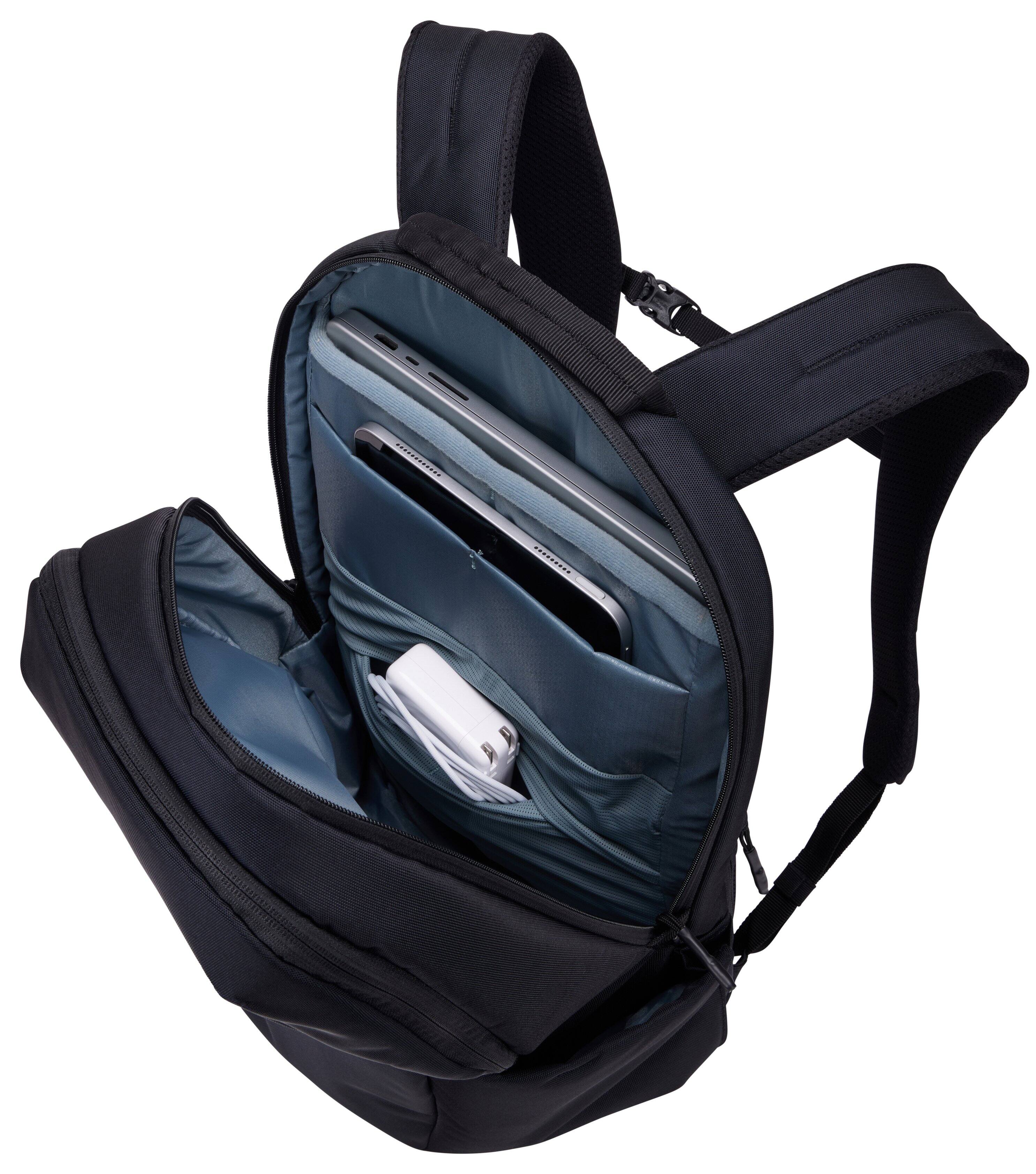 The image shows a black and blue backpack with a laptop compartment. Inside, there is a laptop and a white power bank.