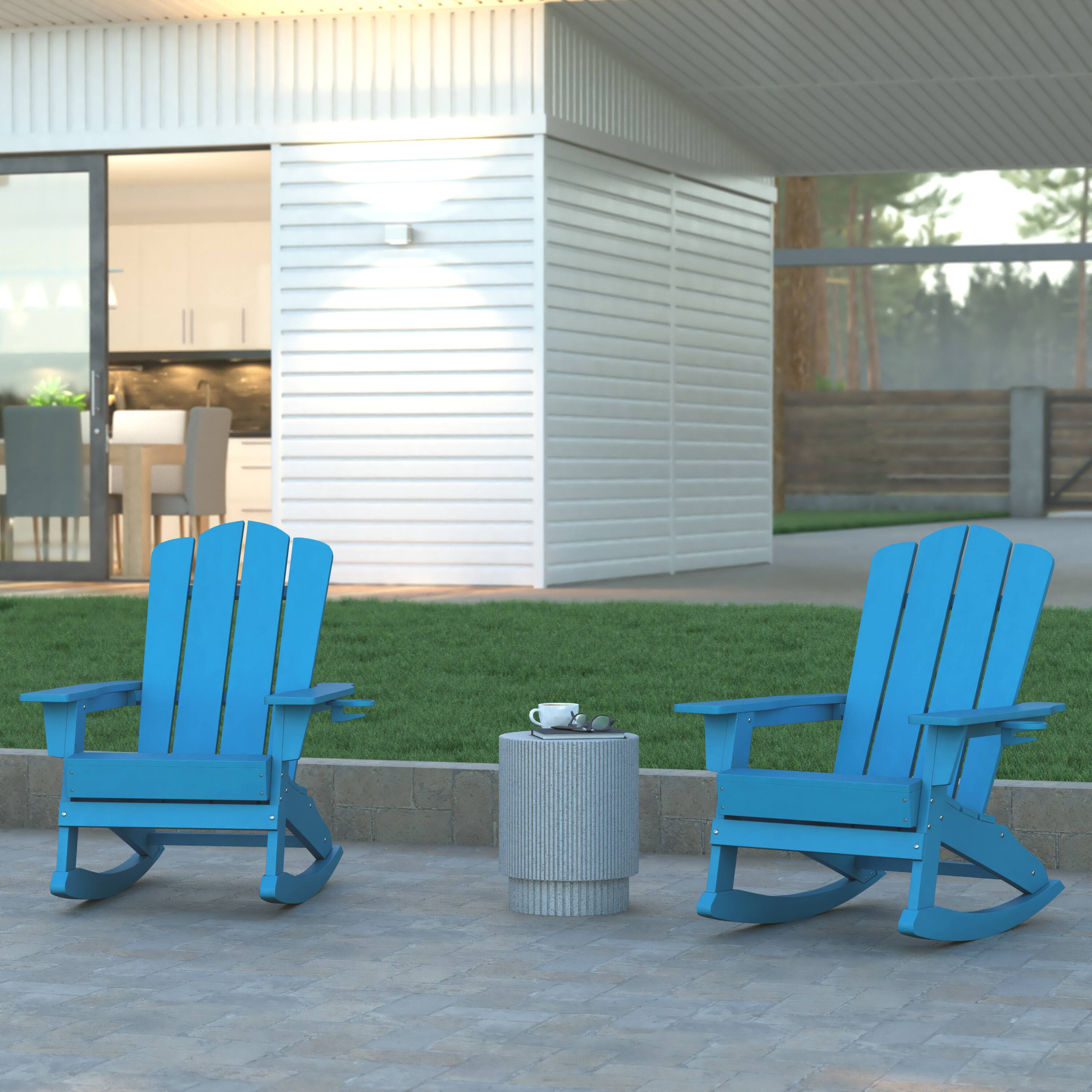 Set of two blue Adirondack rocking chairs in an outdoor setting.