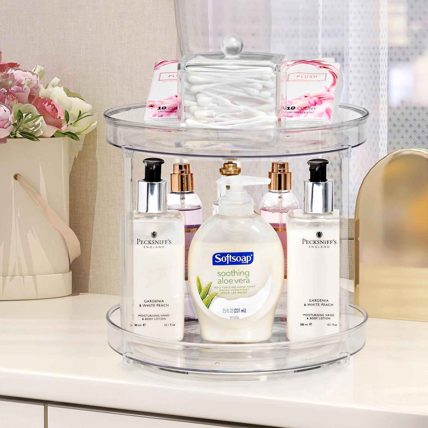 Sure, here is the corrected and grouped text from the image:

---

**Top Shelf:**
- PLUSH 10 COUNT
- PLUSH 10 COUNT

**Middle Shelf:**
- Pecksniff's ENGLAND
- GARDENIA & WHITE PEACH
- MOISTURIZING HAND & BODY LOTION
- 300 ml e
- 10.1 fl oz

- Softsoap
- soothing aloe vera
- MOISTURIZING HAND SOAP
- 75 FL OZ (2.21 L)
- 100 ml e

- Pecksniff's ENGLAND
- GARDENIA & WHITE PEACH
- MOISTURIZING HAND & BODY LOTION
- 300 ml e
- 10.1 fl oz

**Bottom Shelf:**
- (Various small bottles with labels, but text is not clearly readable)

---

This text is grouped according to the items visible on each shelf in the image.