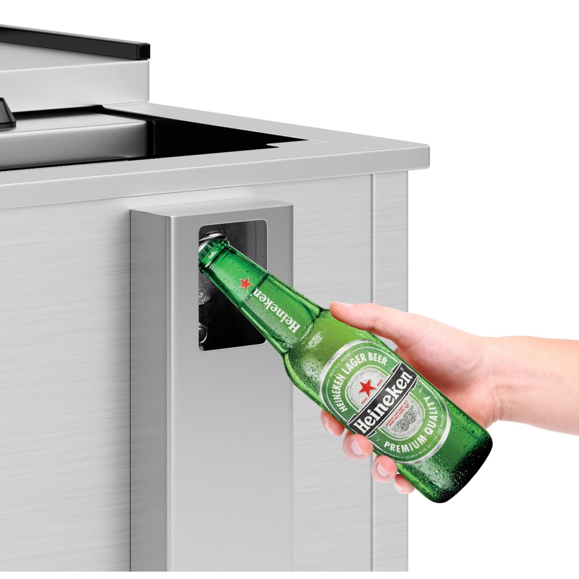 Heineken is a premium lager beer that is known for its quality and taste. The image shows a person holding a bottle of Heineken beer, which is being poured into a bottle opener. The bottle opener is designed to open the bottle with ease and convenience.