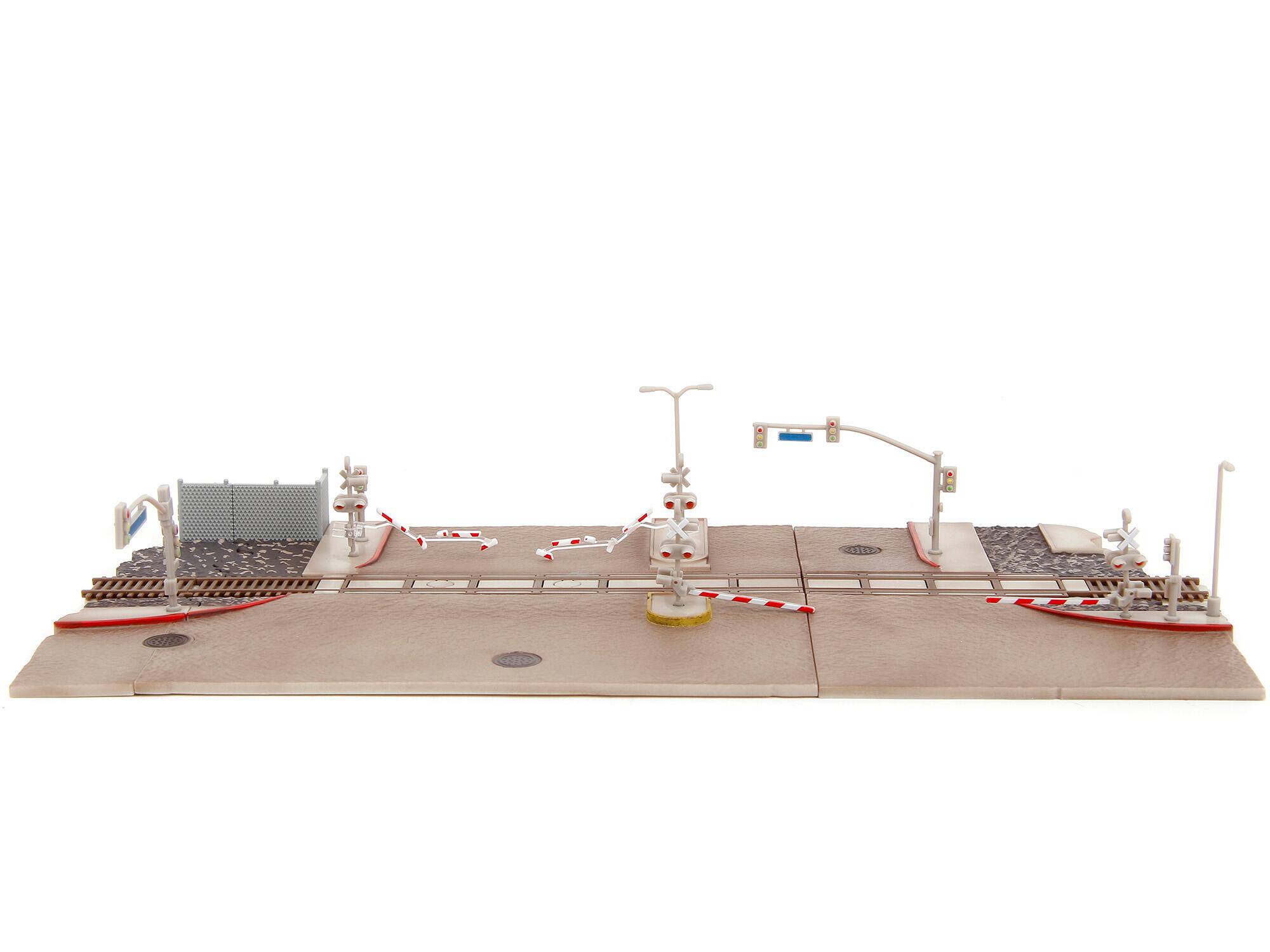The image does not contain any visible text to group or correct. It shows a model of a road crossing with traffic lights, barriers, and other street elements.