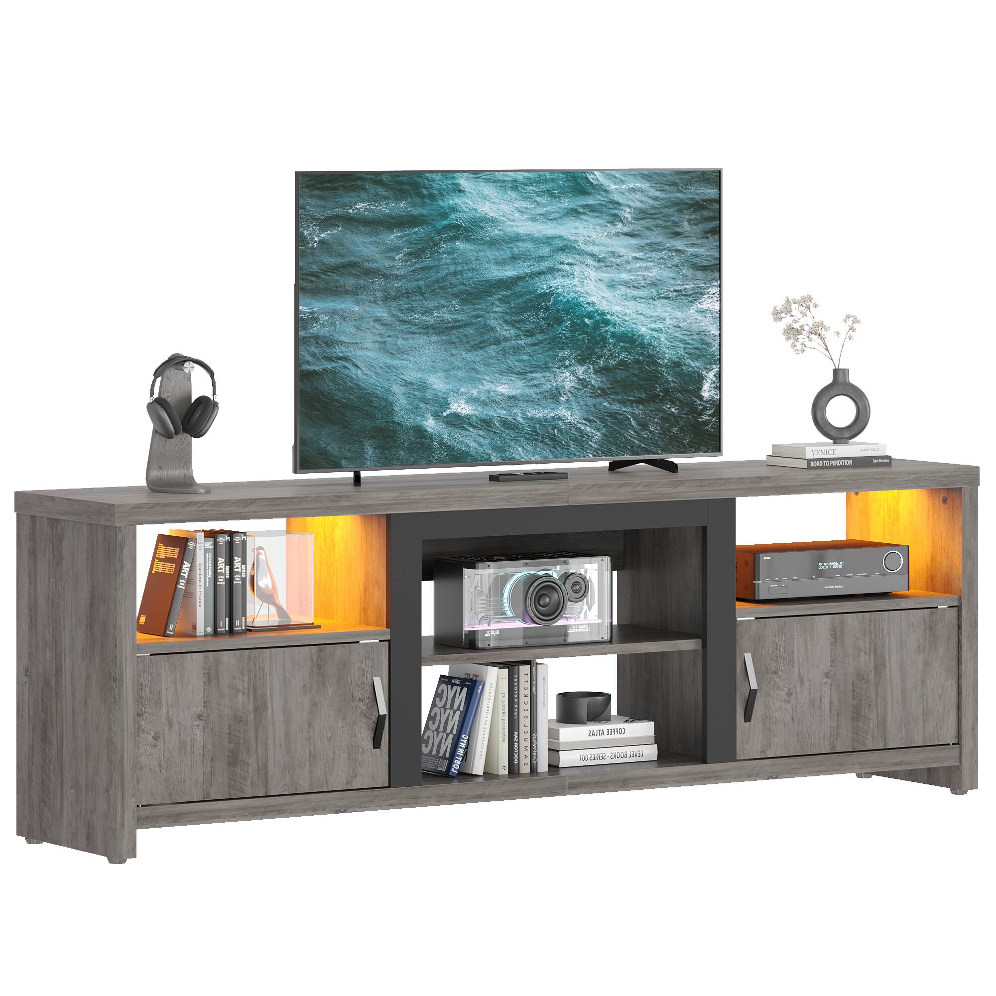 I cannot group or correct the text as it appears to be unrelated to the image. The image features a television sitting on top of a wooden stand, with a bookshelf underneath it. The television is displaying a blue ocean scene, and there are books and a vase nearby.