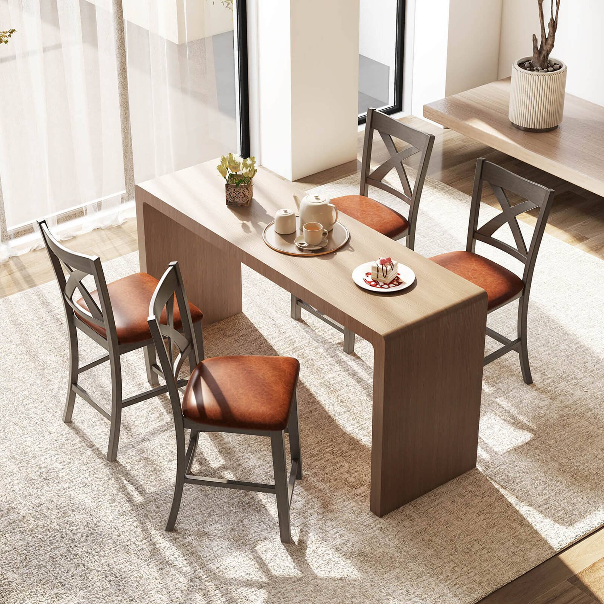 The image shows a wooden dining table with four chairs around it. The table is set with a plate of food and a cup of coffee. There are also two potted plants in the room, one on the left side and the other on the right side of the table. The chairs are arranged in a way that allows for comfortable conversation and dining. The overall atmosphere of the room appears to be inviting and cozy.