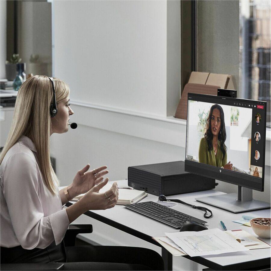 The image does not contain any text that needs to be grouped or corrected. It shows a person participating in a video conference.