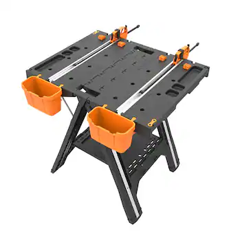 The image shows a black table with orange holders on each side. The table is designed for use with a drill and has a black and orange color scheme. The table is made by the company Altia.