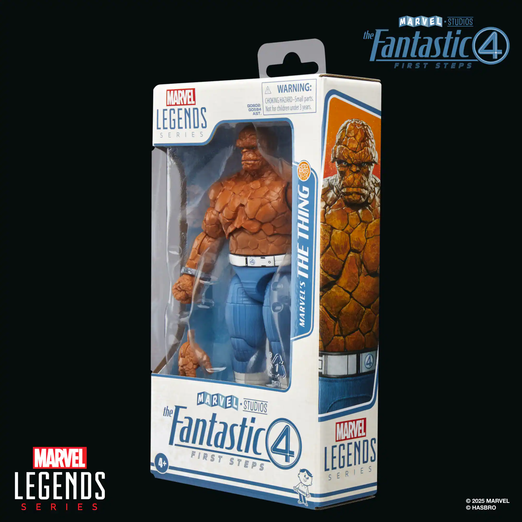 The image features a box containing a Marvel Legends action figure of The Thing from the Fantastic Four. The box is blue and white, and it has a warning label on the back, indicating that small parts may pose a choking hazard. The action figure is displayed in the box, showcasing its design and detail. The packaging is designed to protect the figure and make it easy to store or display.