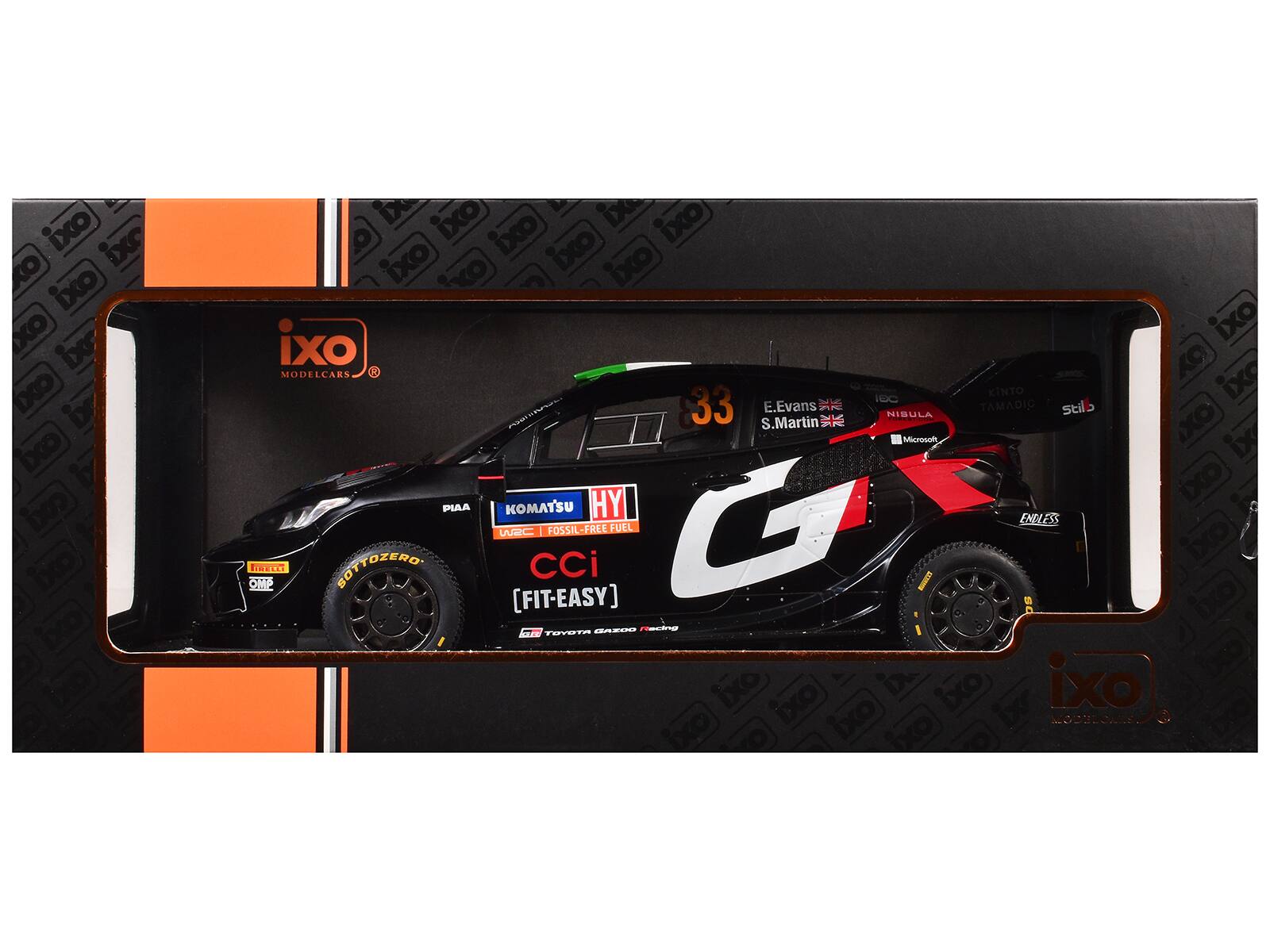 Sure, here is the corrected and grouped text from the image:

---

**Front of the Box:**

- ixo
- MODELCARS
- [FIT-EASY]

**On the Car:**

- 33
- E. Evans
- S. Martin
- HY
- KOMATSU
- PIAA
- UGRC | FOSSIL-FREE FUEL
- CCI
- [FIT-EASY]
- TOYOTA GAZOO Racing
- ENDLESS
- SOTTZERO
- MICROSOFT
- NIBULA
- KINTO
- TAMADIC
- stilb
- ixo

**On the Box:**

- ixo
- MODELCARS

---