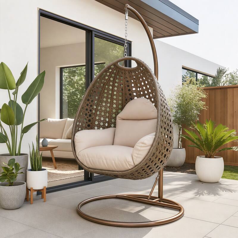 Angle. LeisureMod - LeisureMod Beige Wicker Hanging Egg Chair with Iron Stand & Cushion - All-Weather Single Outdoor Patio Swing - Beige.
