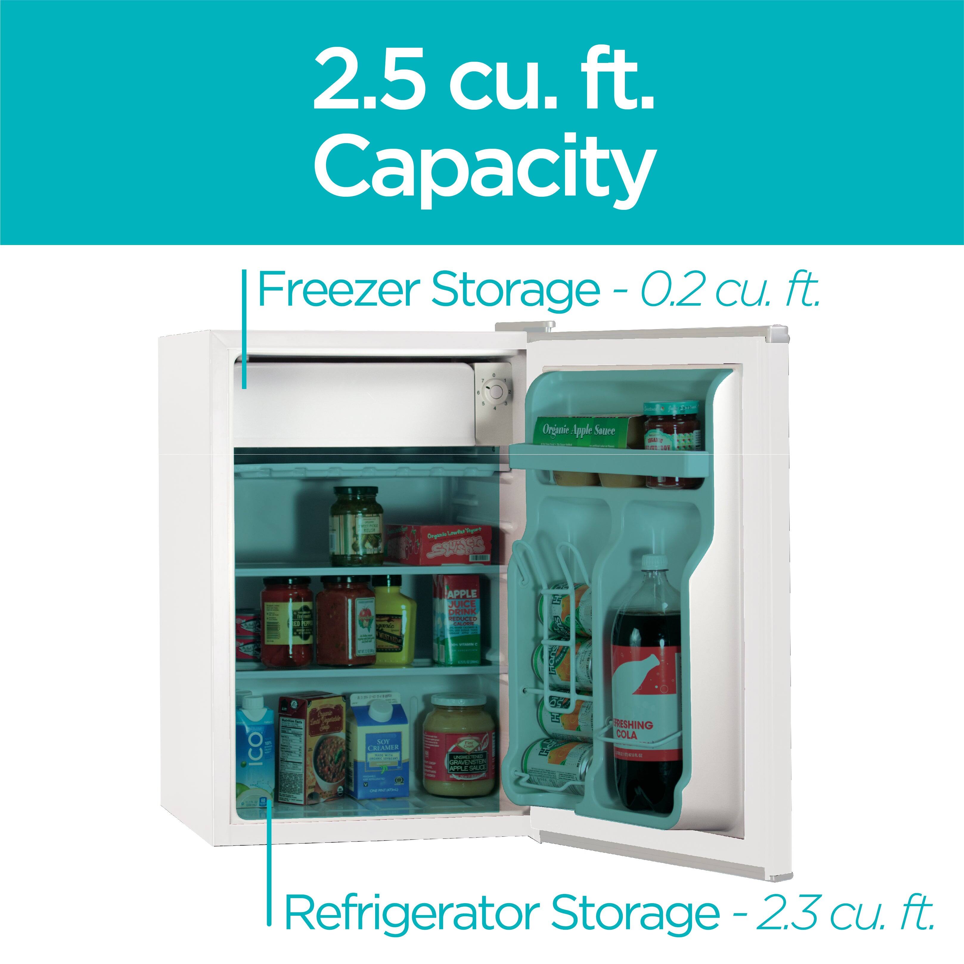 The text in the image can be grouped and corrected as follows:

- **2.5 cu. ft. Capacity**
- **Freezer Storage - 0.2 cu. ft.**
- **Refrigerator Storage - 2.3 cu. ft.**

The image shows a refrigerator with its freezer and refrigerator sections open, displaying various items such as apple juice, condiments, and a bottle of soda.