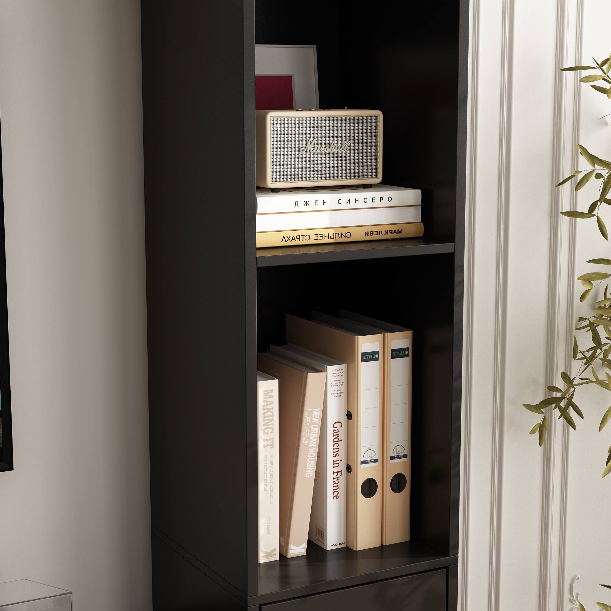 The image features a black bookshelf filled with various books and a radio. The books are arranged in different positions, with some standing upright and others lying horizontally. The radio is placed on top of the bookshelf, adding a unique touch to the display. The collection of books and the radio create an interesting and visually appealing scene.
