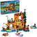 The image features a Lego Friends Adventure Camp playset, which includes a water sports area and a campground. The playset is designed for children aged 7 and up and has 628 pieces. The scene includes a group of people, some of whom are wearing backpacks, and a boat. There is also a dog present in the scene. The playset is designed to encourage imaginative play and creativity among children.