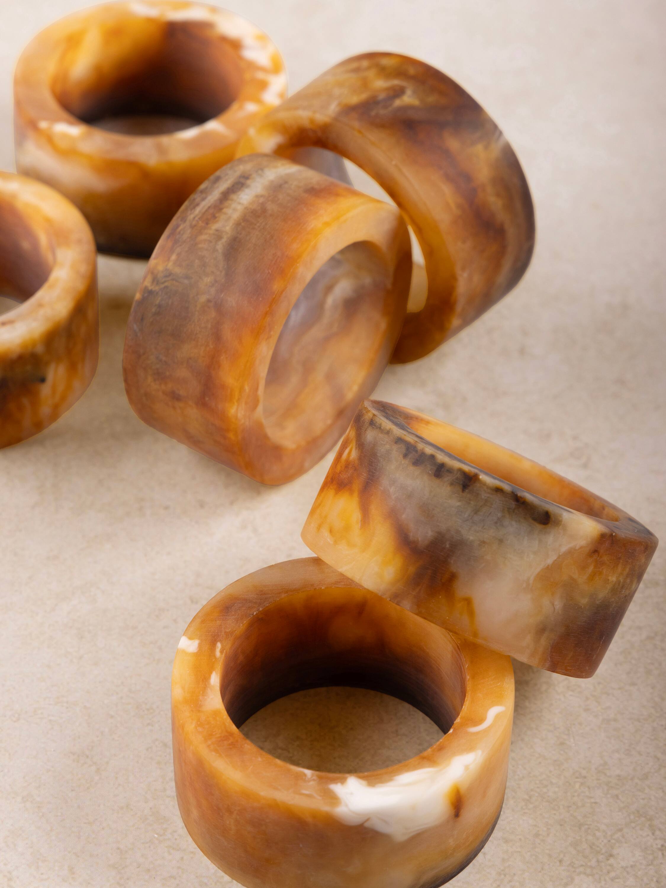 Left. GAURI KOHLI - Kampai Napkin Rings - Shades of brown.