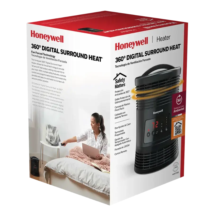 The image features a woman sitting on a bed, holding a laptop. She is using a Honeywell heater, which is placed on the floor next to her. The heater has a digital display and is designed to provide warmth and comfort. The box for the heater is also visible, indicating that it is a new purchase. The woman appears to be enjoying her time on the bed while using her laptop.
