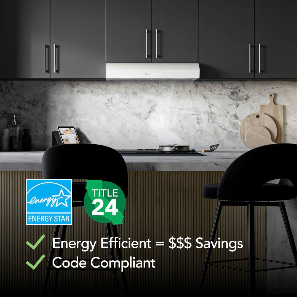 The image features a kitchen with a marble countertop and black chairs. The kitchen is equipped with an Energy Star appliance, which is designed to be energy-efficient and save money on utility bills. The chairs are positioned in front of the counter, and there is a bowl on the countertop. The image is advertising the energy-efficient appliance, emphasizing the potential savings and the code compliance of the product.