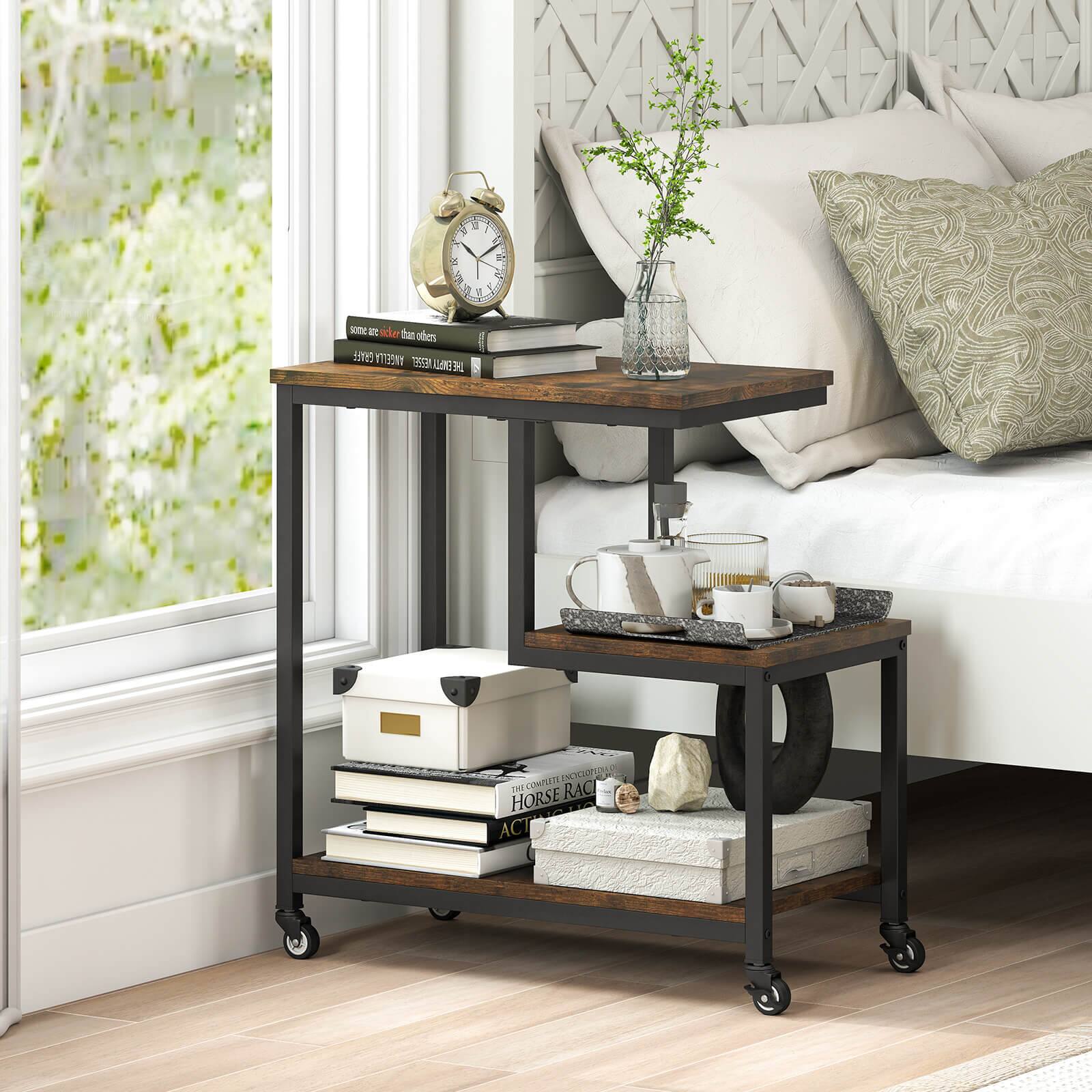 A small table with a clock, books, and a vase of flowers on it.