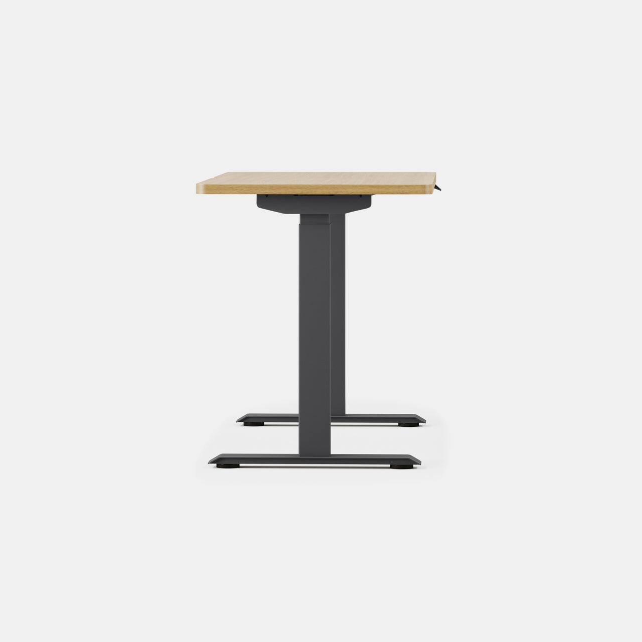 Angle. Branch Furniture - Duo Standing Desk 48" – Adjustable Desk with OLED Control Panel, Frameless Design & Compact Footprint - Woodgrain / Charcoal.