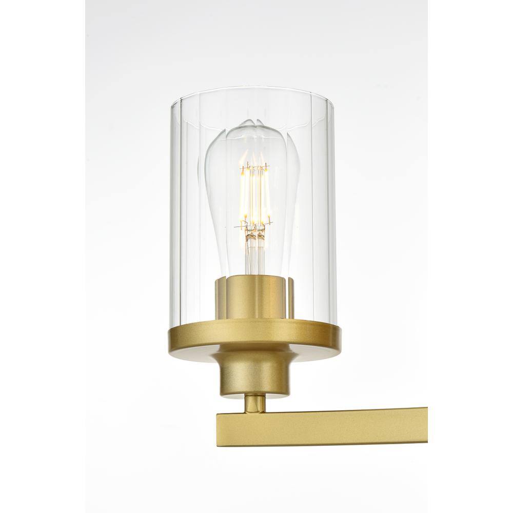 Left. Living District - Saanvi 3 light Brass and Clear Bath Sconce - Brass And Clear.