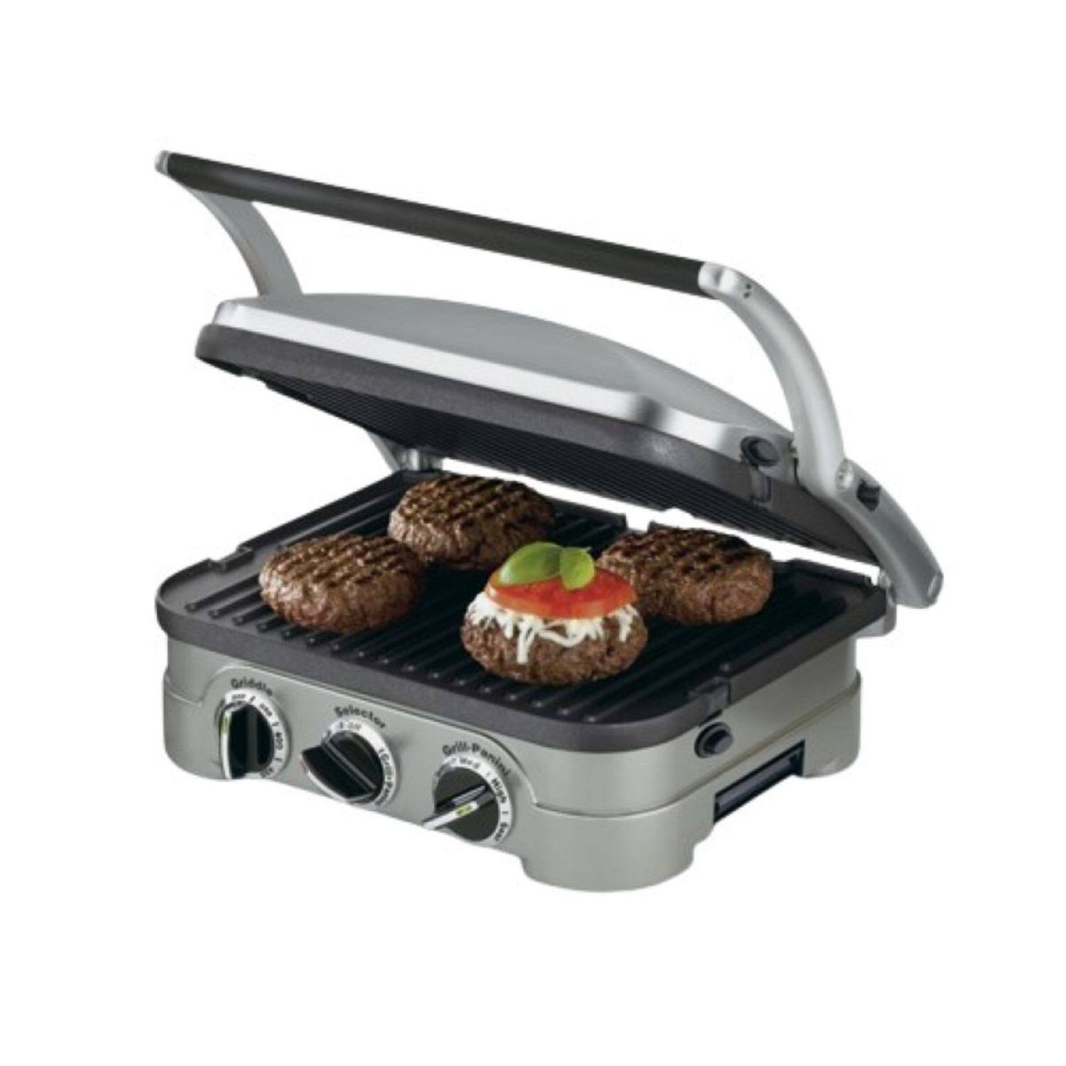 The image features a griddle grill with four hamburgers on it. The hamburgers are placed on the grill, and they are topped with tomatoes. The grill is open, allowing the viewer to see the delicious meal being cooked.