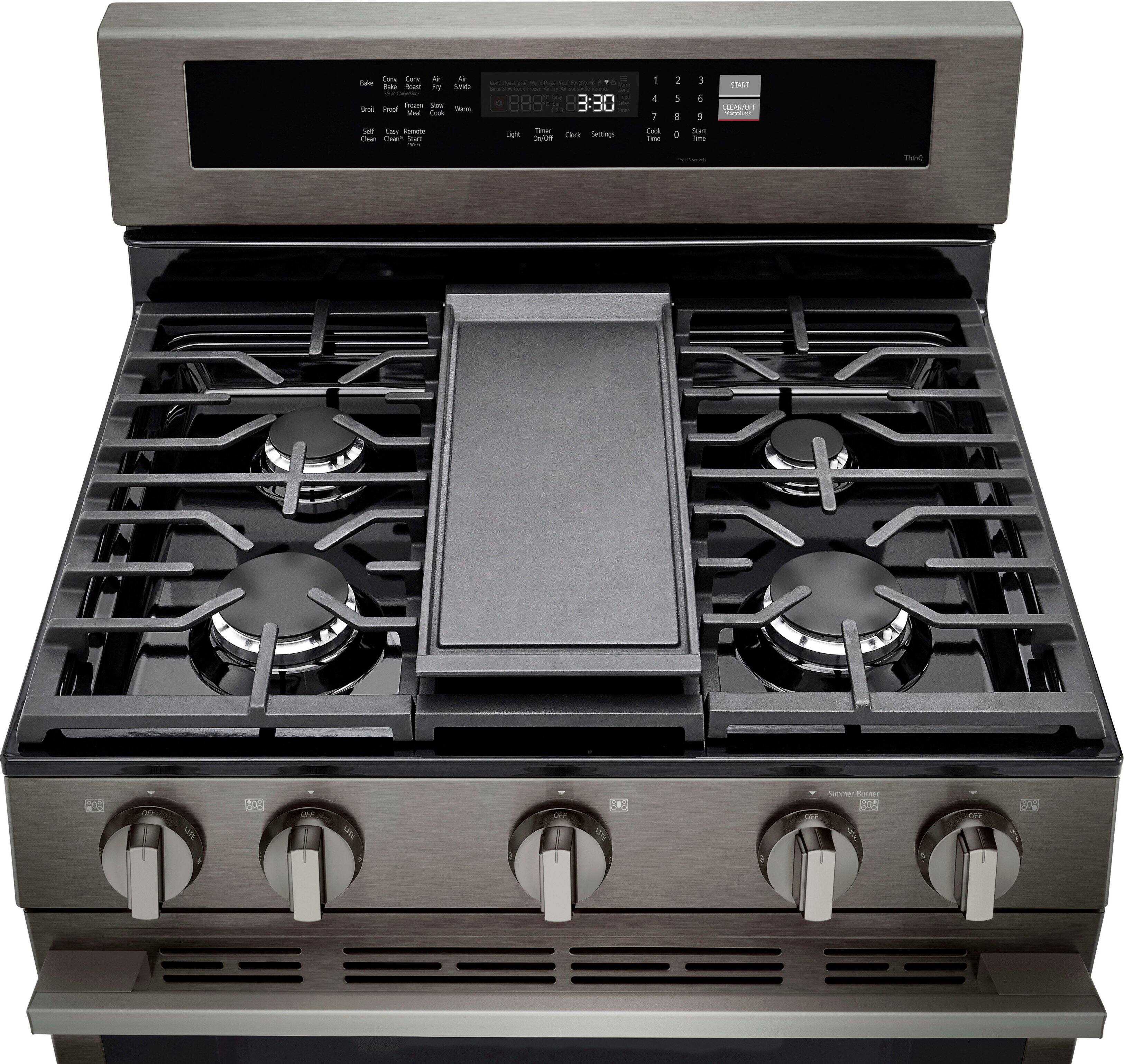 The image features a stainless steel stove with a black cooktop. The stove has four burners, and the oven is located below the cooktop. The time displayed on the stove is 3:30.